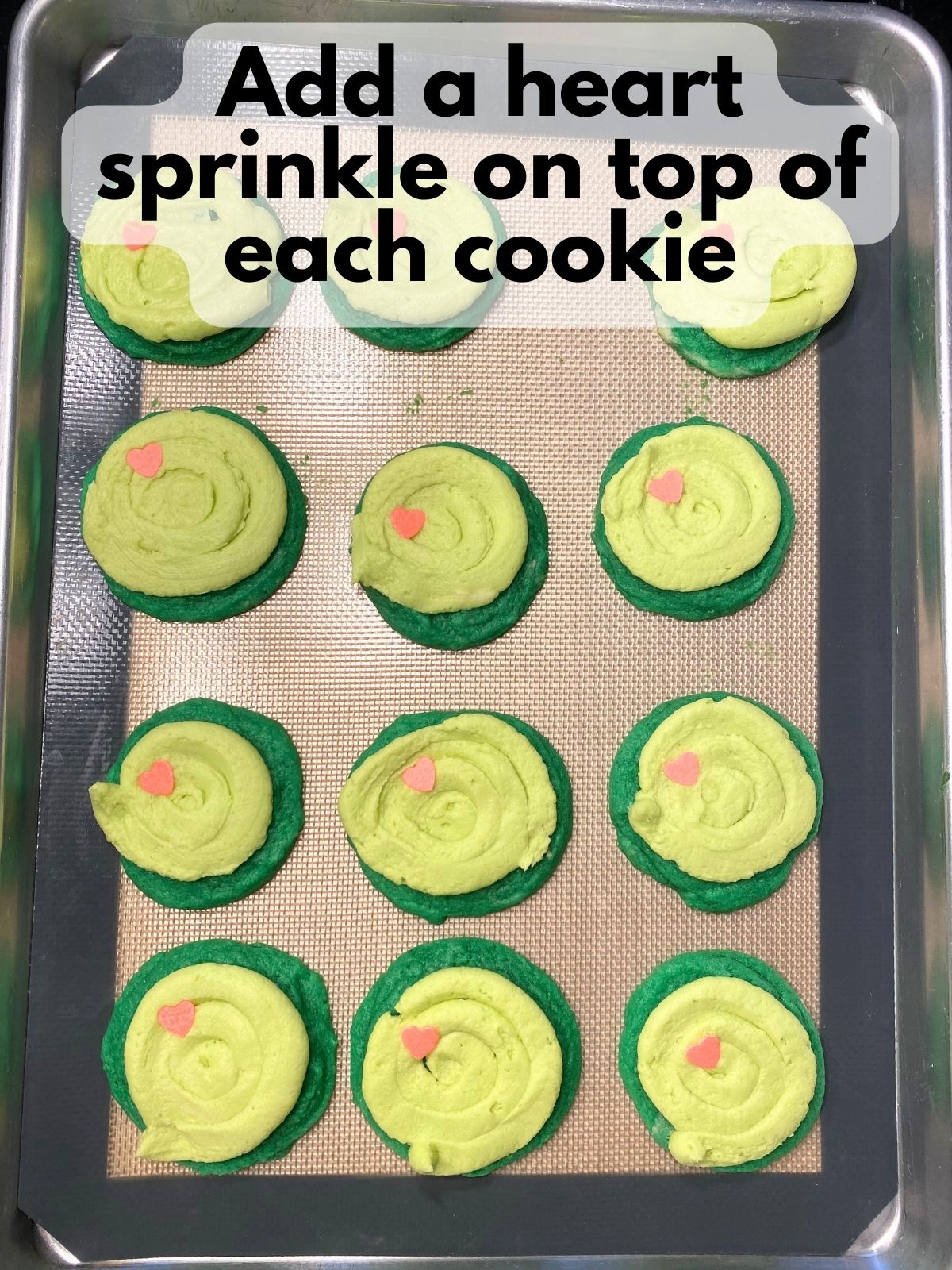 frosted cookies decorated with a heart sprinkle