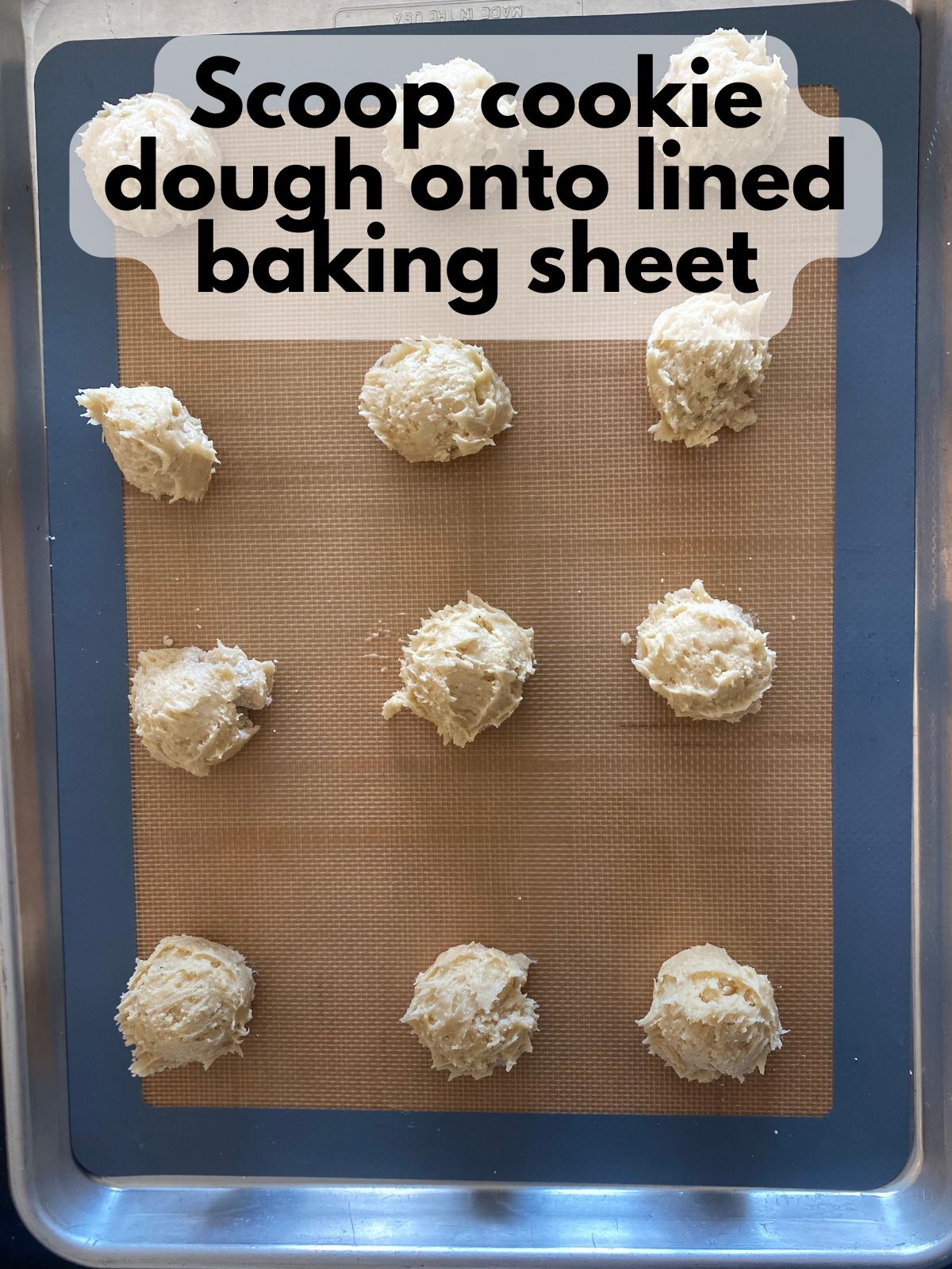 cake mix cookie dough scooped onto a line baking sheet