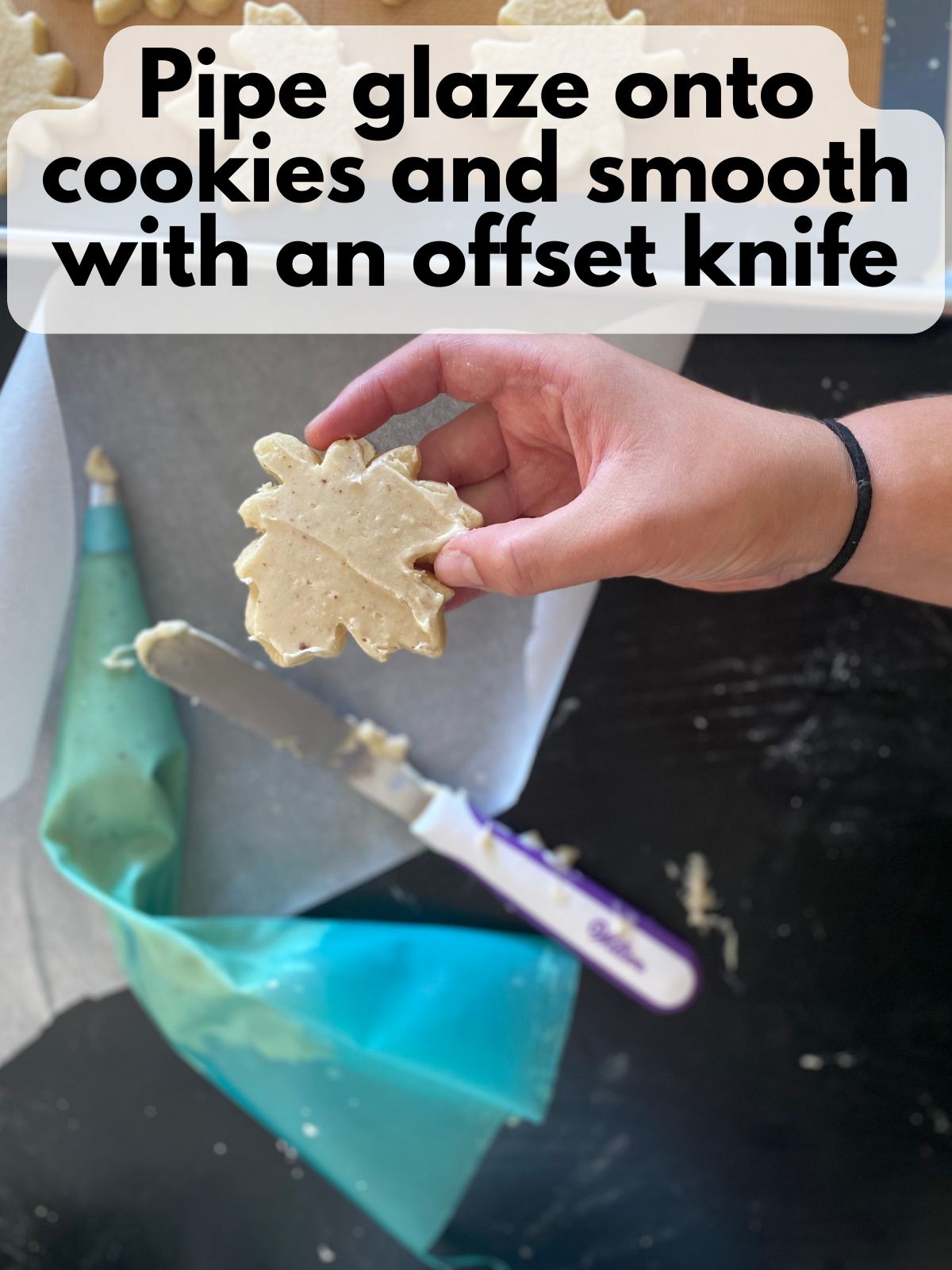 brown butter maple glaze spread on a maple leaf cookie