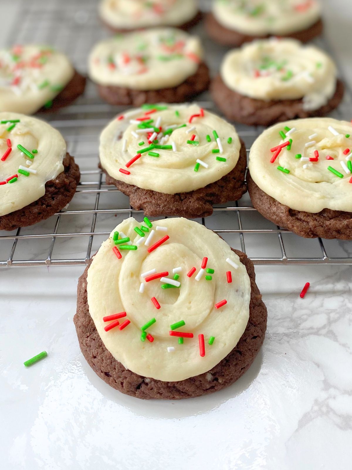 chocolate cake mix cookies with vanilla frosting and Christmas sprinkles