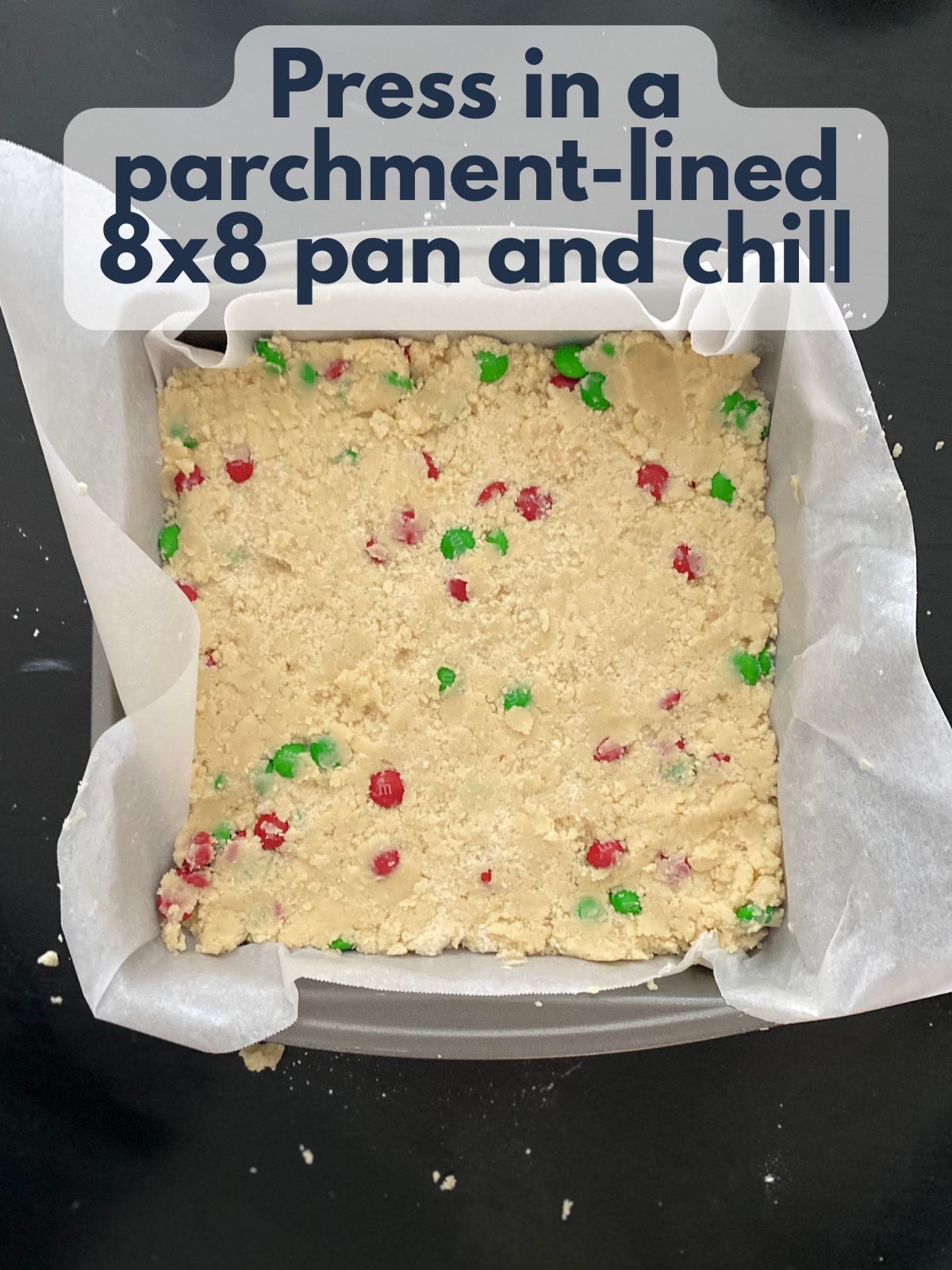 M&M shortbread dough pressed into an 8x8 pan