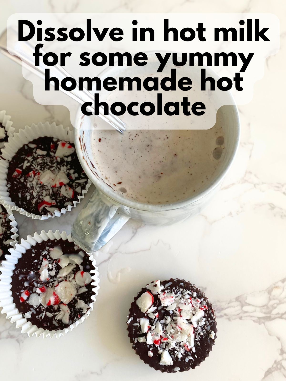 Christmas hot chocolate puck sitting next to a mug of hot chocolate