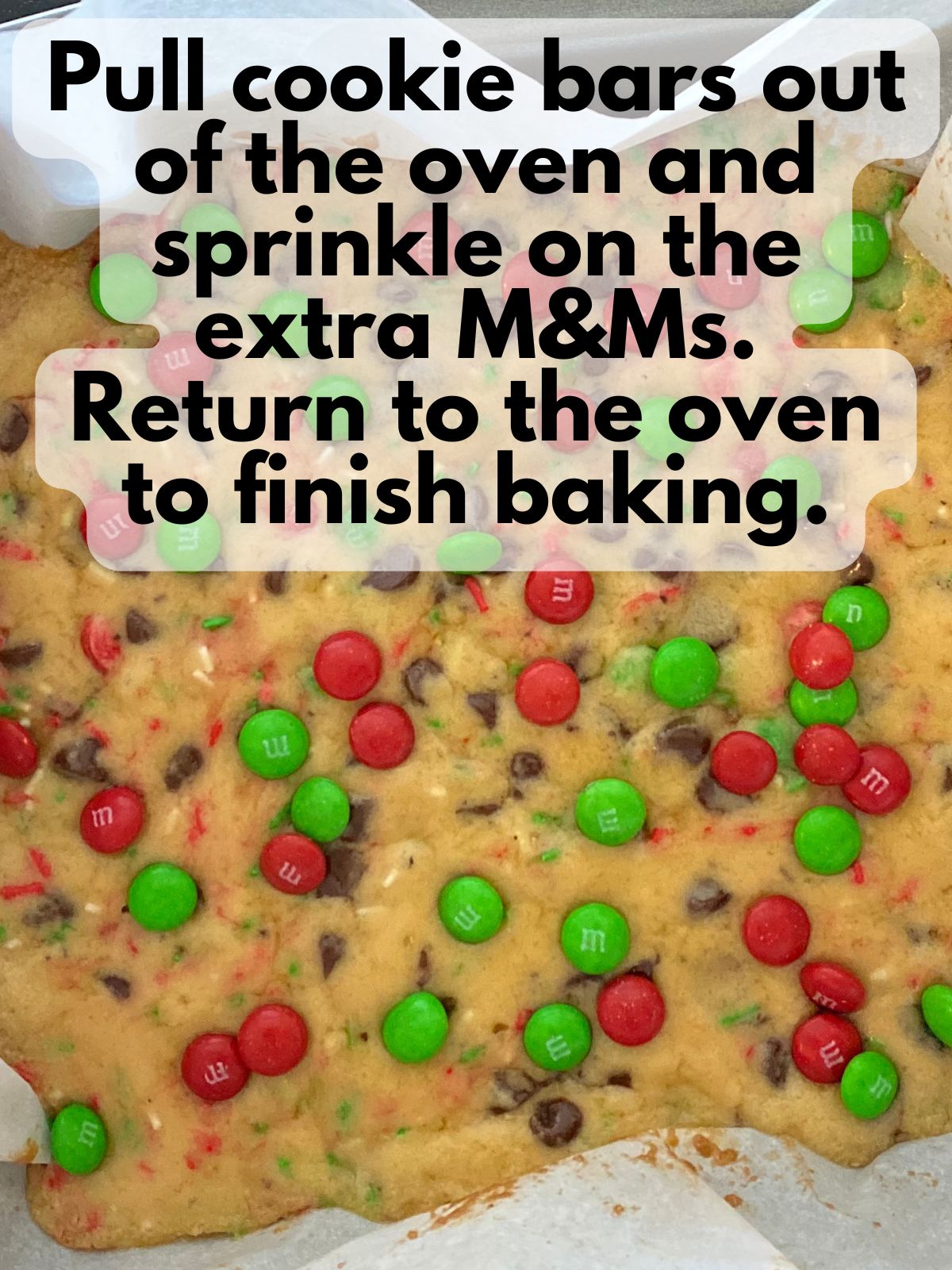 parbaked M&M cookie bars with extra M&Ms sprinkled on top