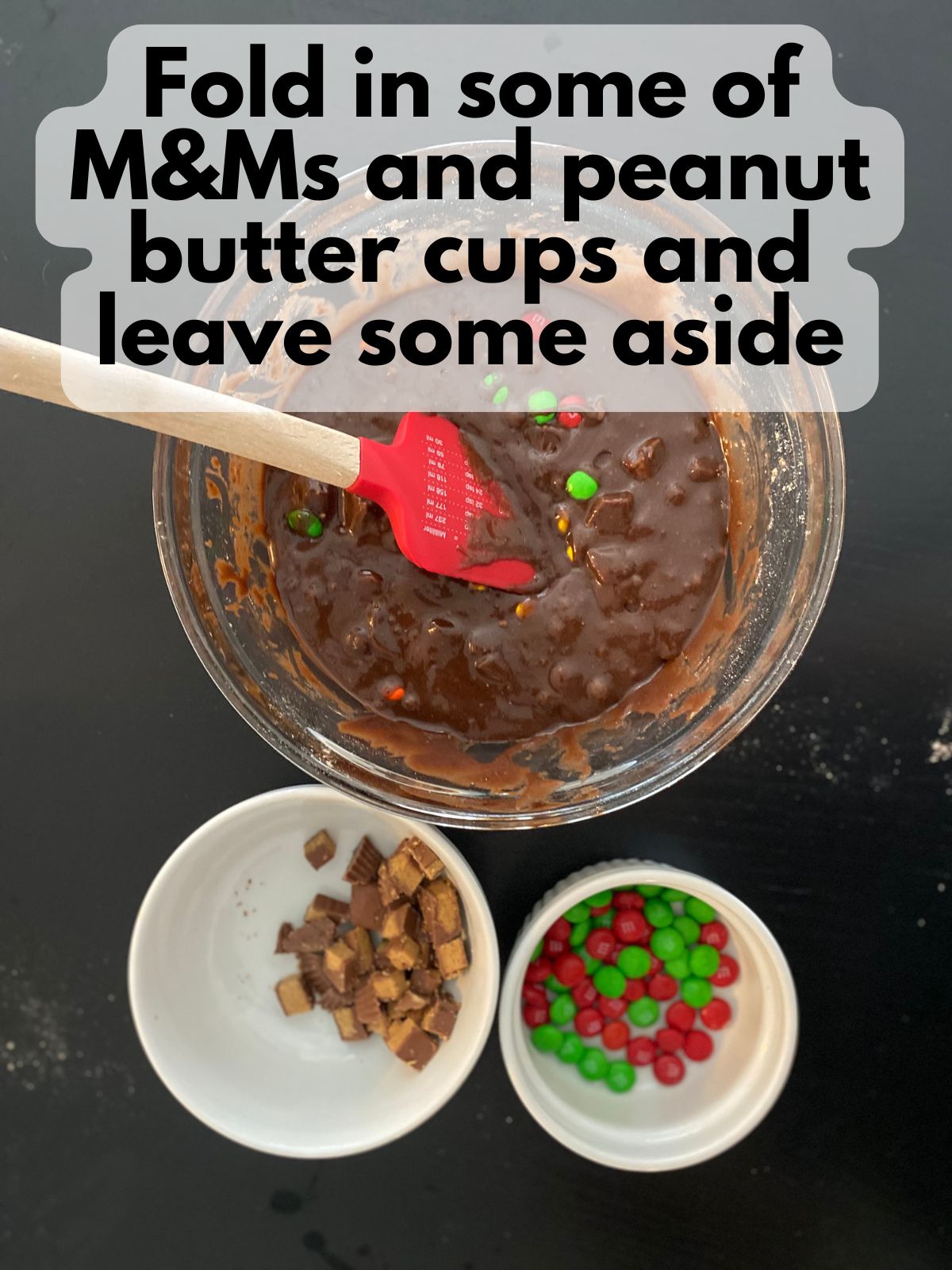 brownie batter with chopped peanut butter cups and M&Ms folded in