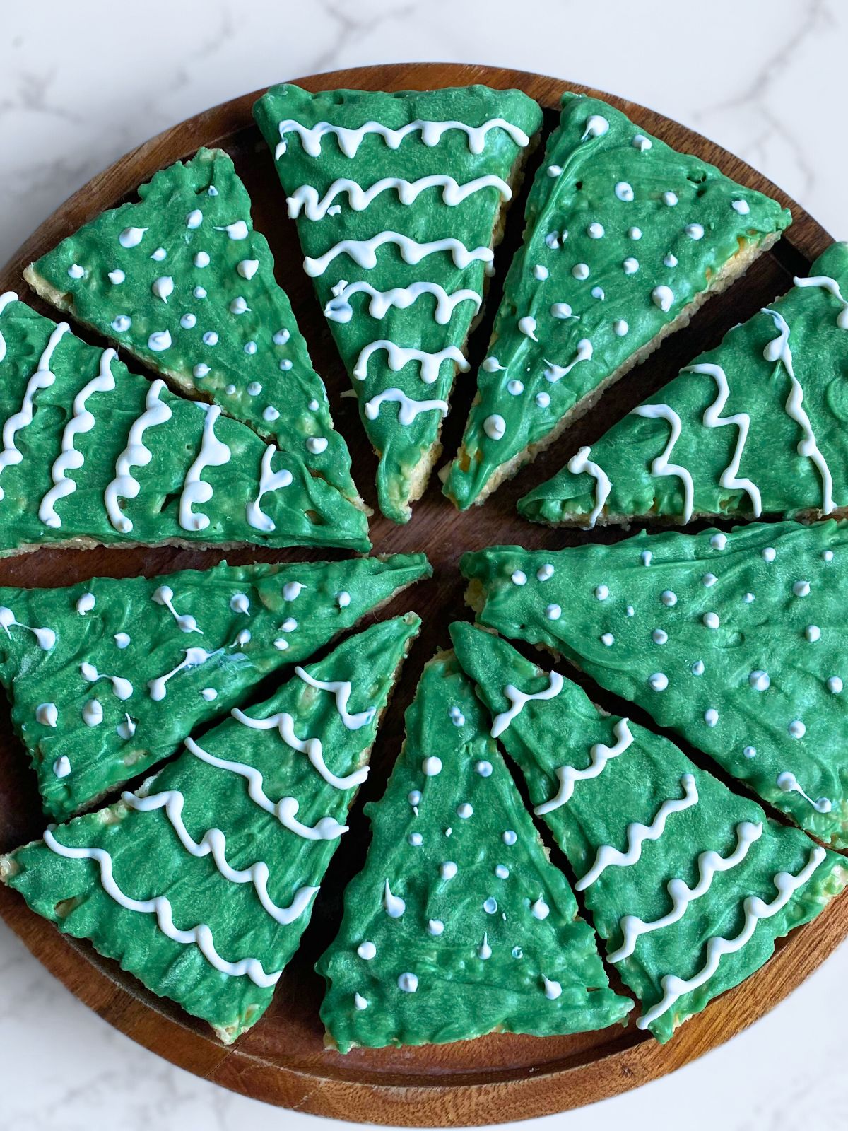 triangular rice krispie treats decorated like Christmas trees