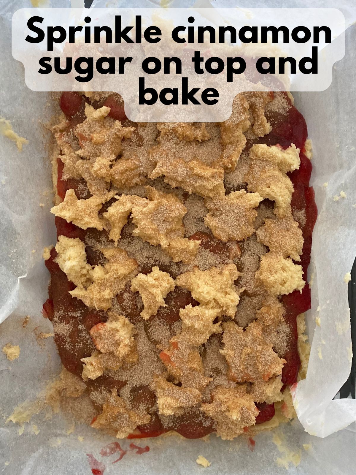 cinnamon sugar sprinkled on top of unbaked cherry sugar cookie bars