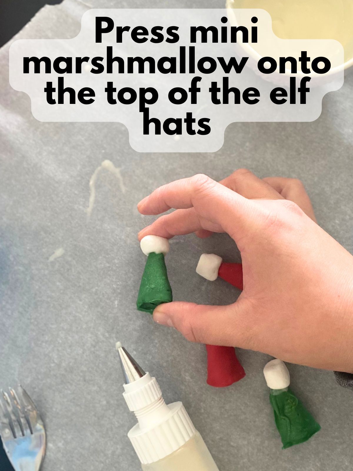 mini marshmallow being pressed onto chocolate covered Bugle