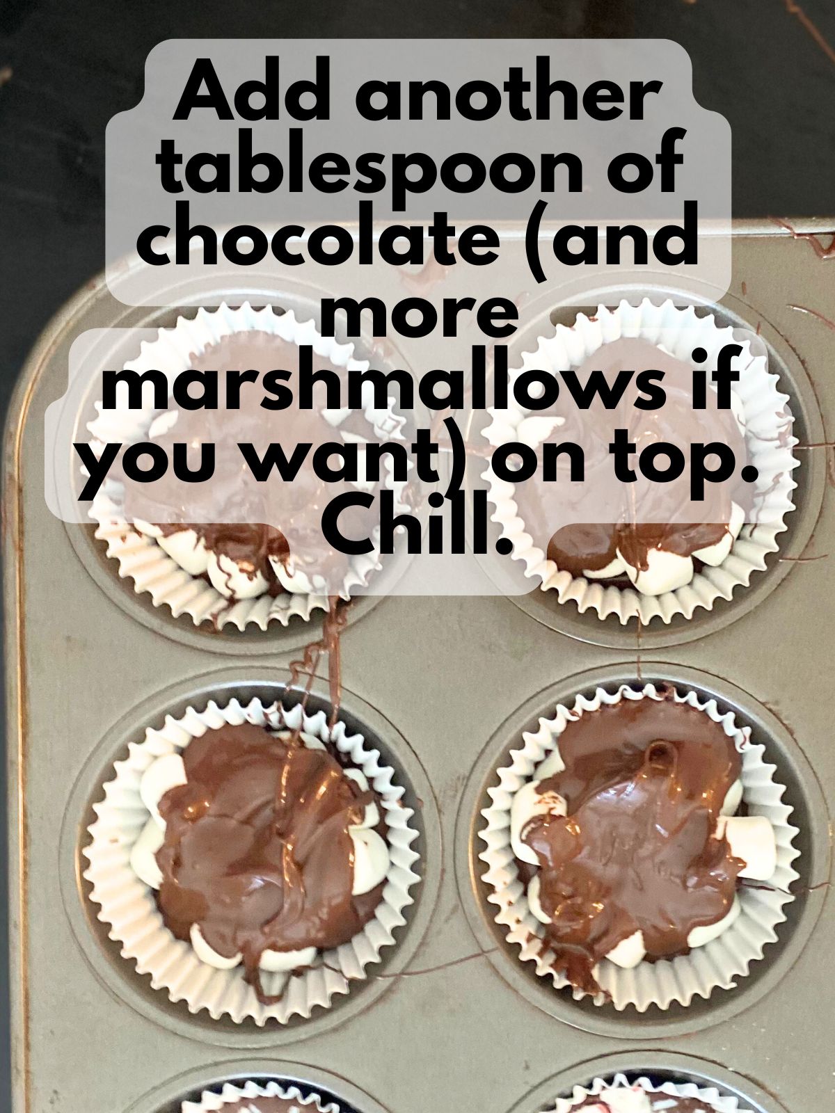 melted chocolate poured over mini marshmallows in cupcake tin