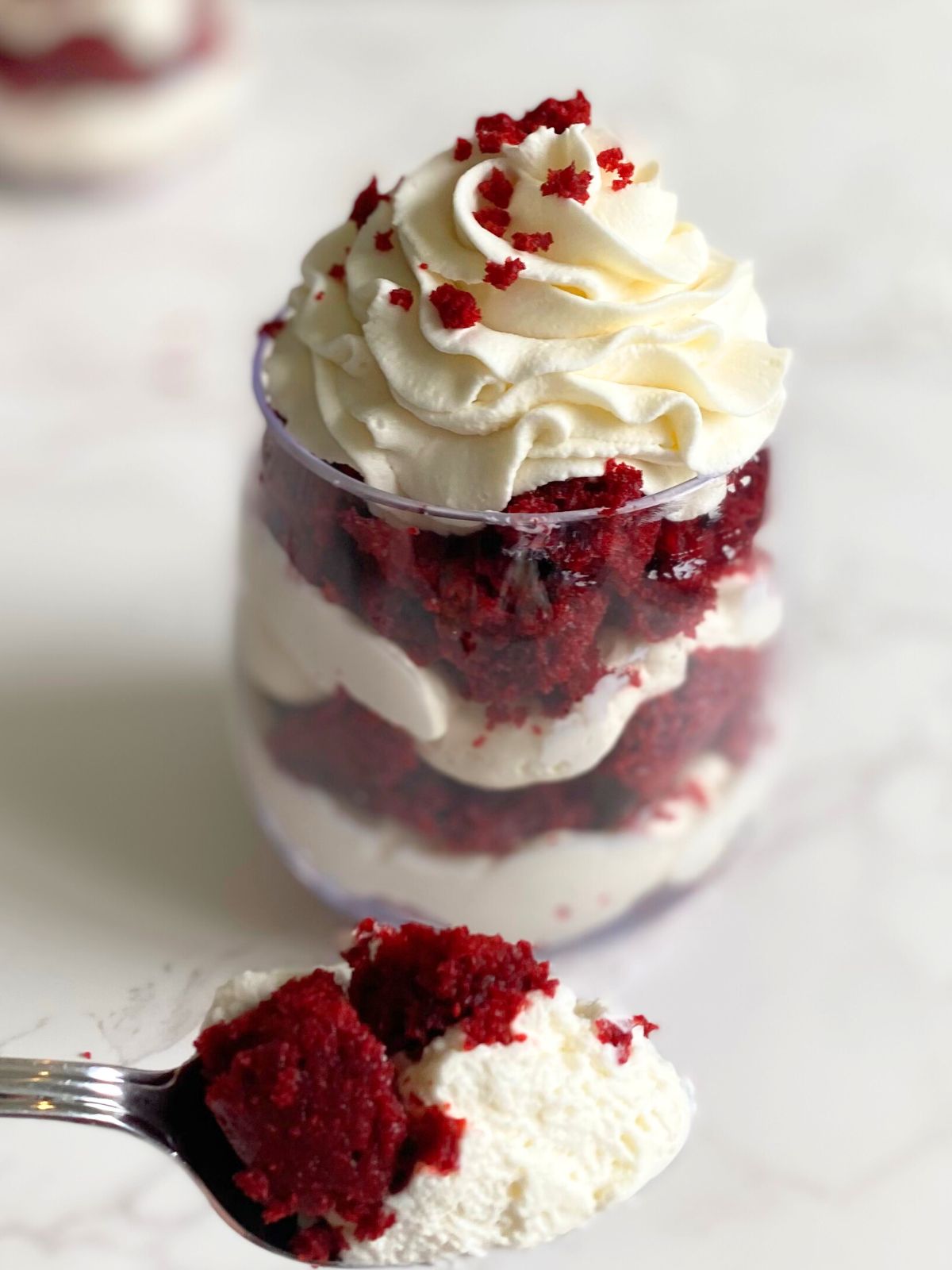 red velvet cheesecake parfait with a bite taken out of it