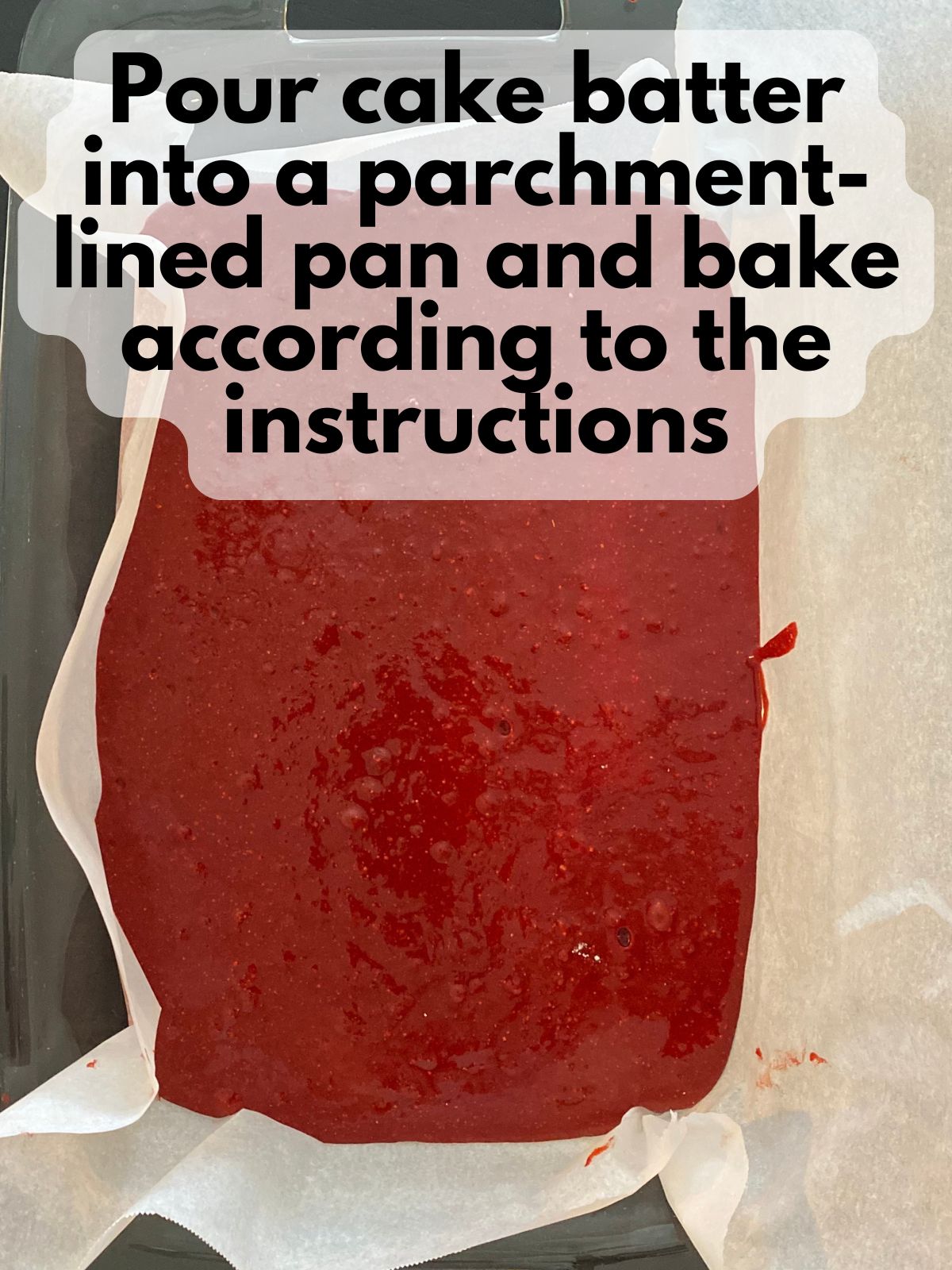 red velvet cake batter in a parchment-lined 9x24 pan