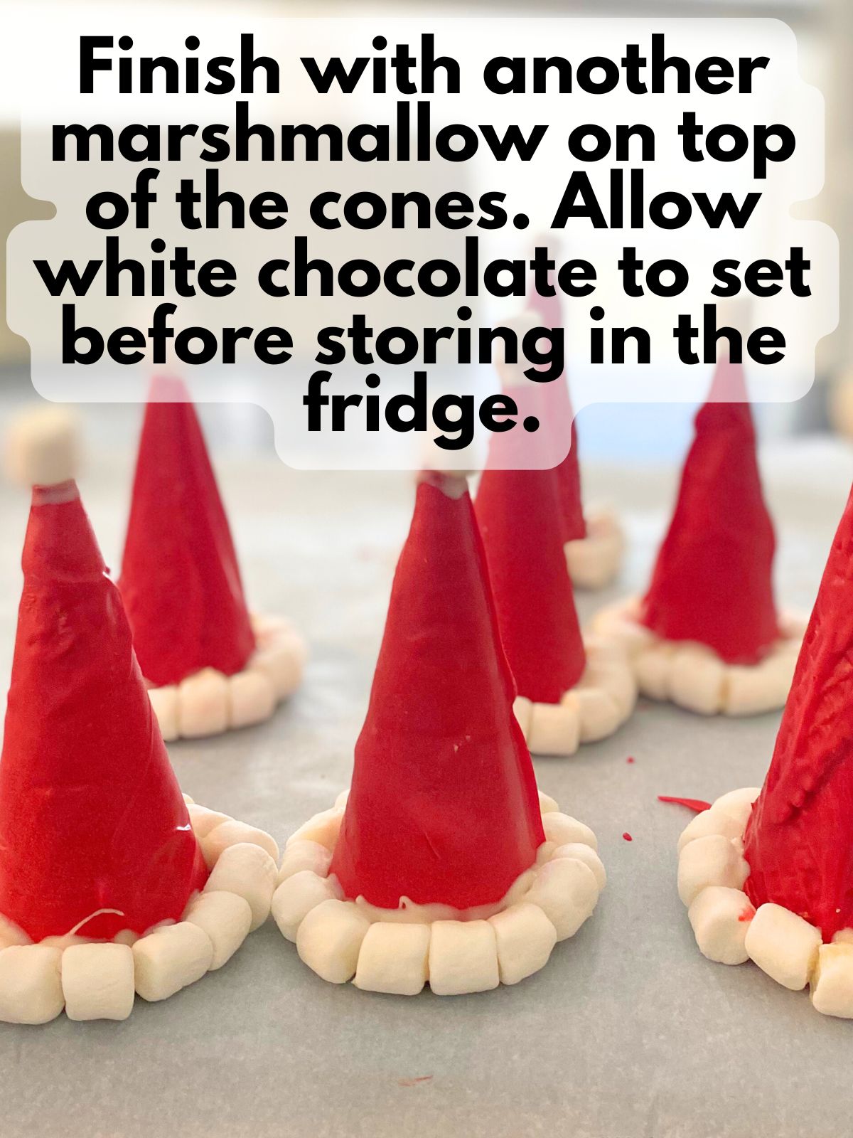 decorated santa hat cones resting on parchment paper