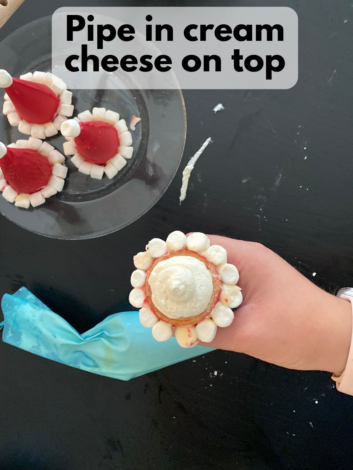 cream cheese filling piped inside santa hat