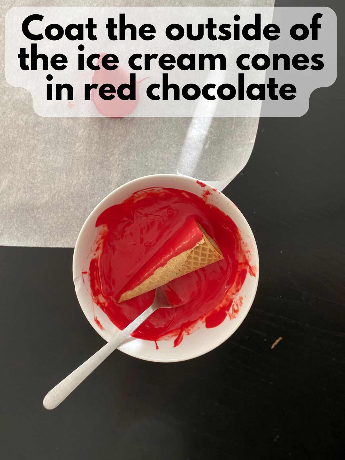 ice cream cone in a bowl with melted red chocolate
