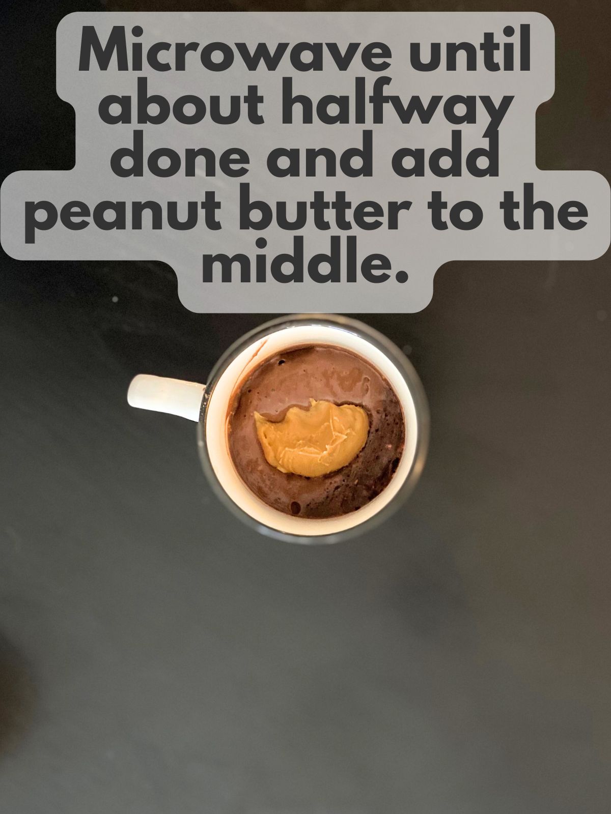 dollop of peanut butter in the middle of par-baked mug cake