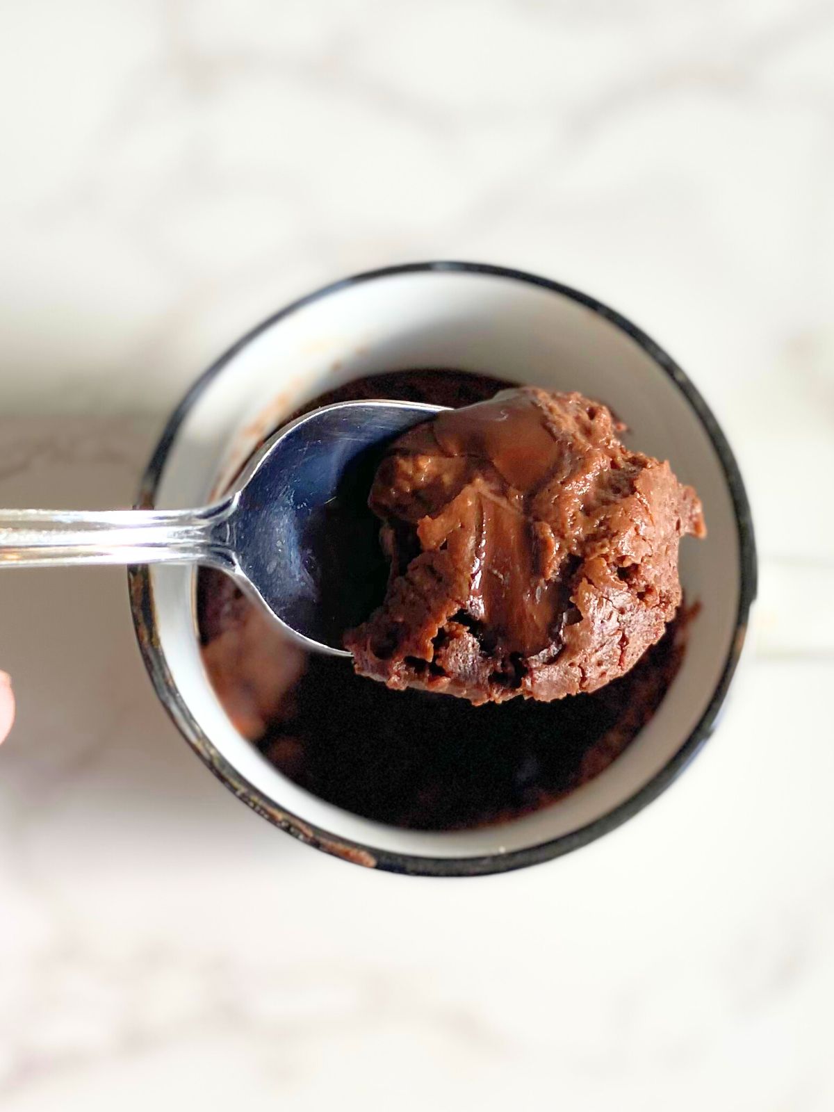 a bite of chocolate lava protein mug cake
