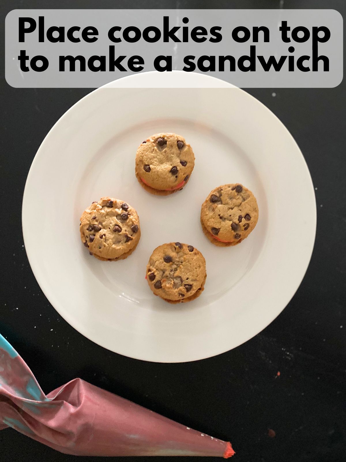 cookie sandwiches with red buttercream frosting in the middle
