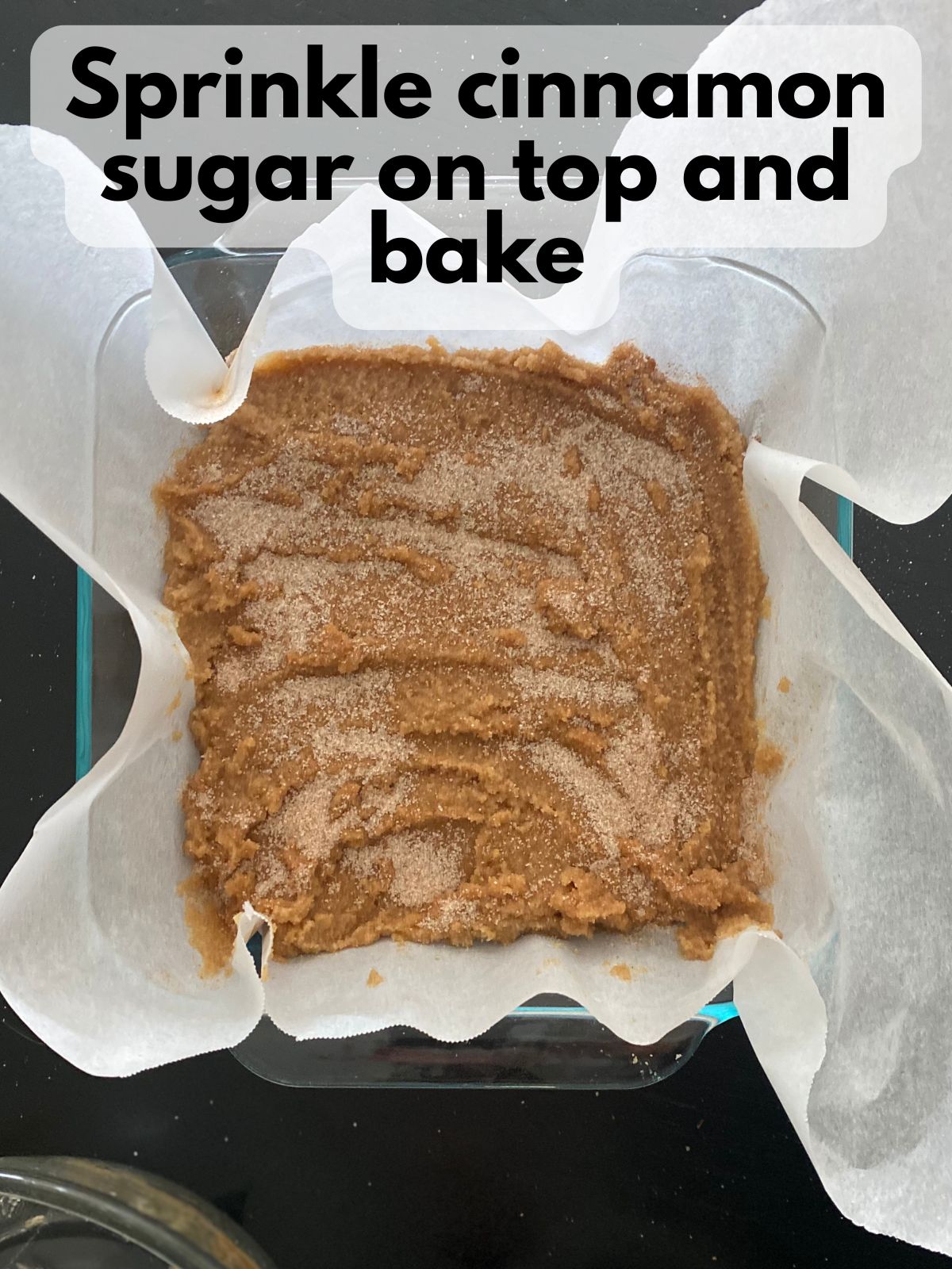 cinnamon sugar topping sprinkled over unbaked snickerdoodle bars