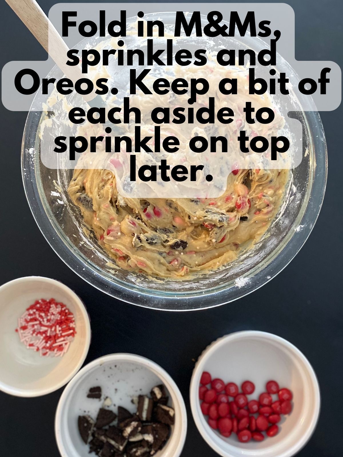 blondie batter with M&Ms, Oreos and sprinkles folded in. Some M&M's, Oreos and sprinkles are kept separate.