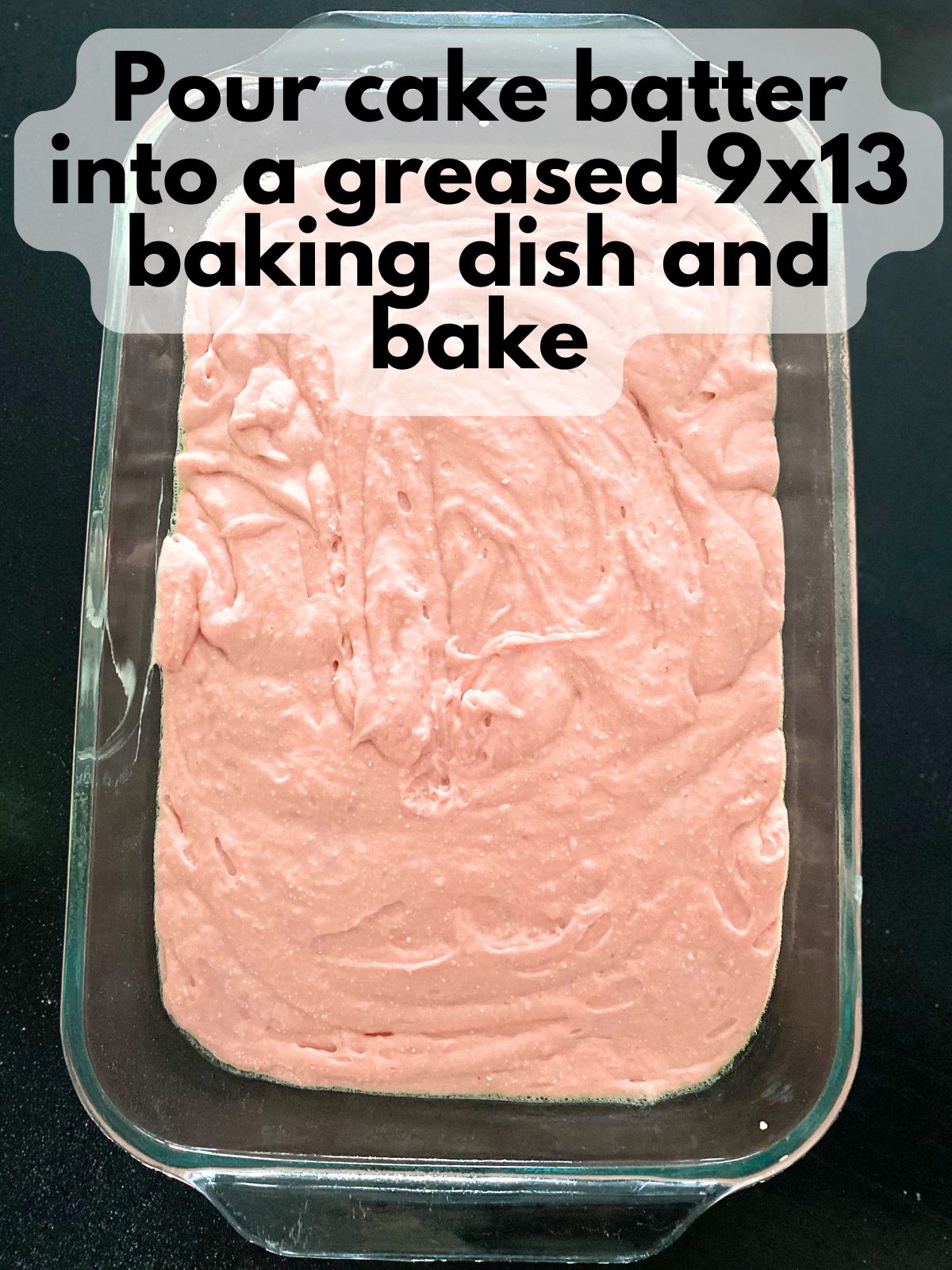 strawberry cake batter in a 9x13 baking pan