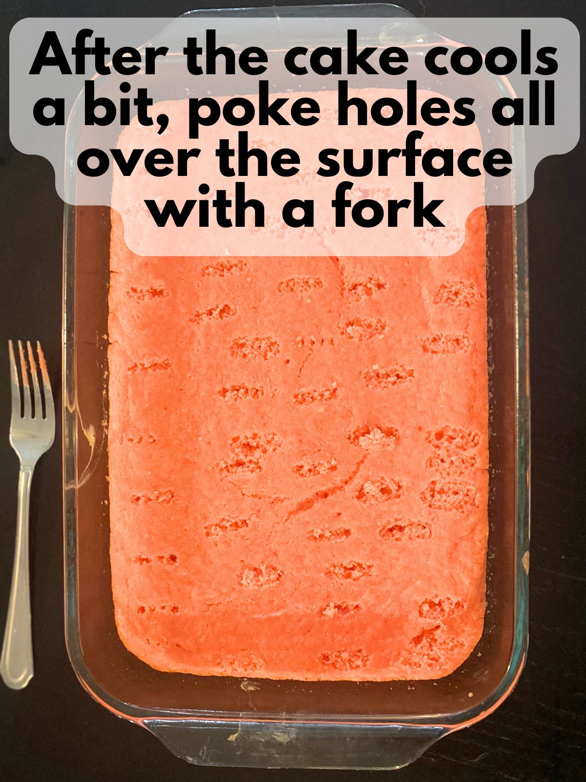 baked strawberry cake with holes poked in it