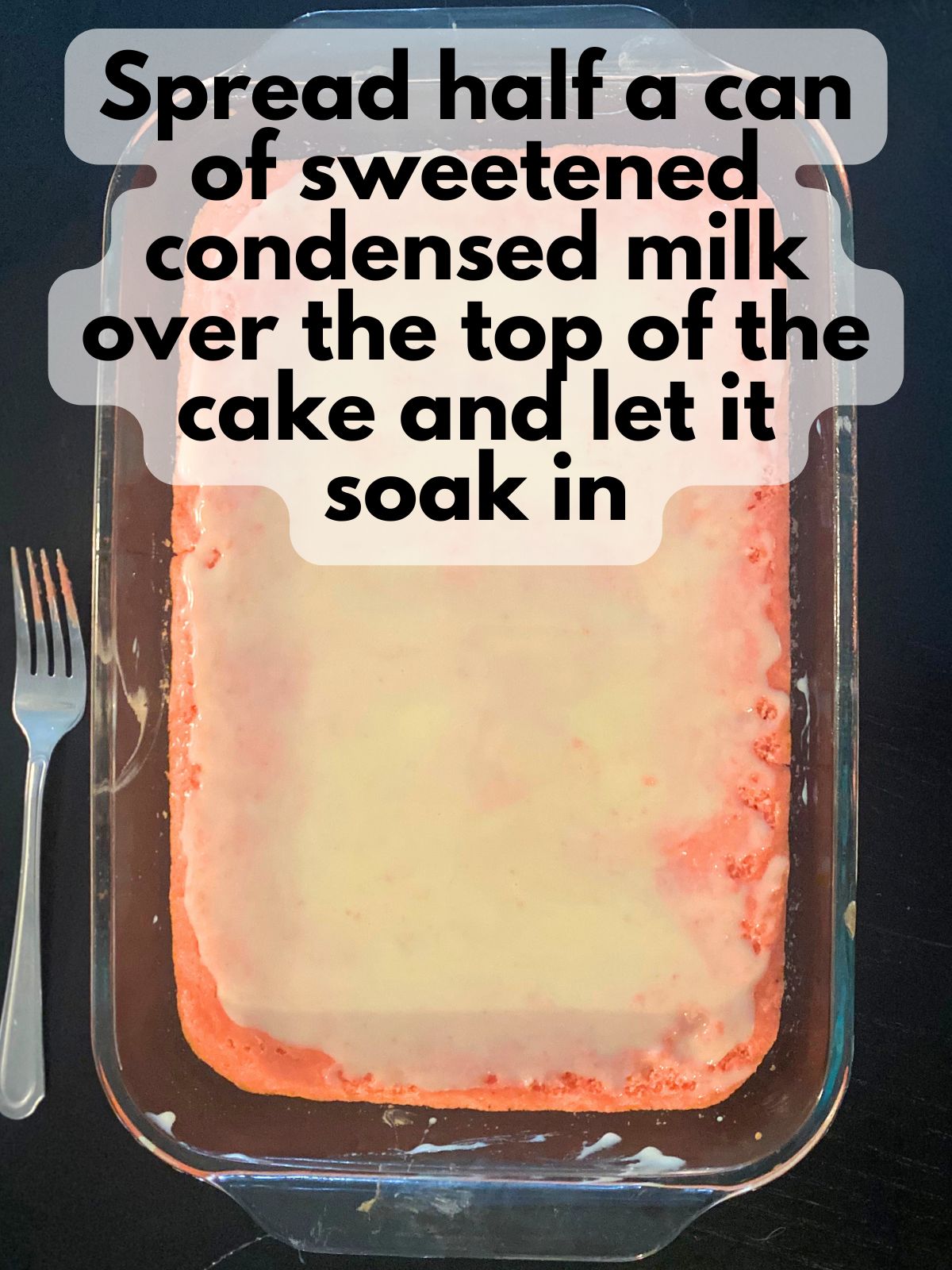 baked strawberry cake with condensed milk spread on top