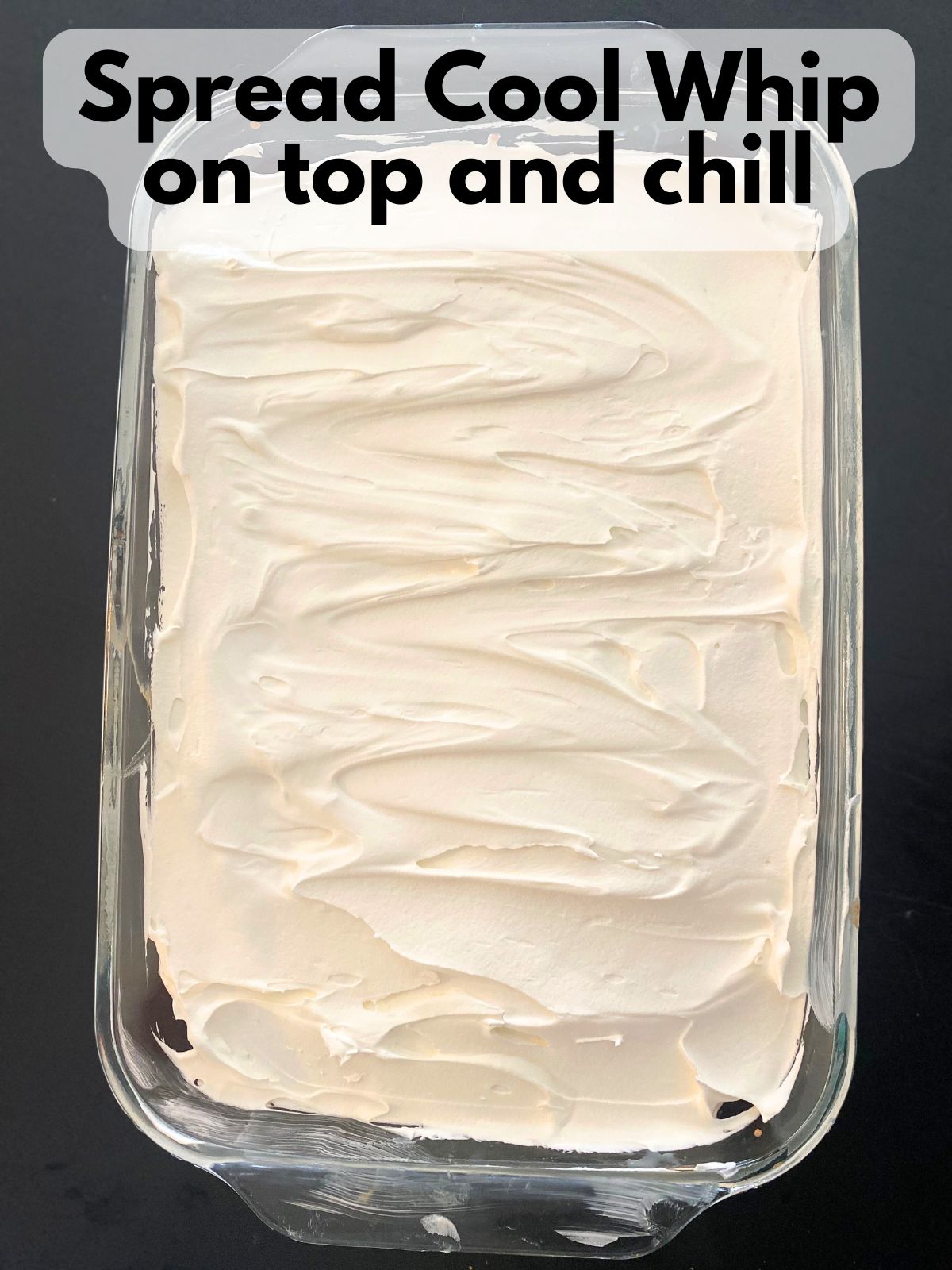 strawberry poke cake with cool whip spread on top