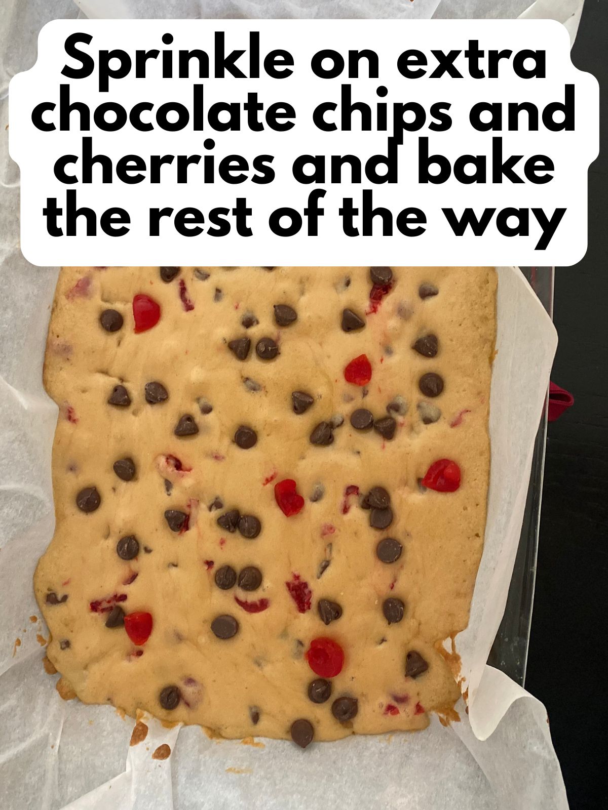 par-baked cookie bars with extra chocolate chip and cerries sprinkled on top