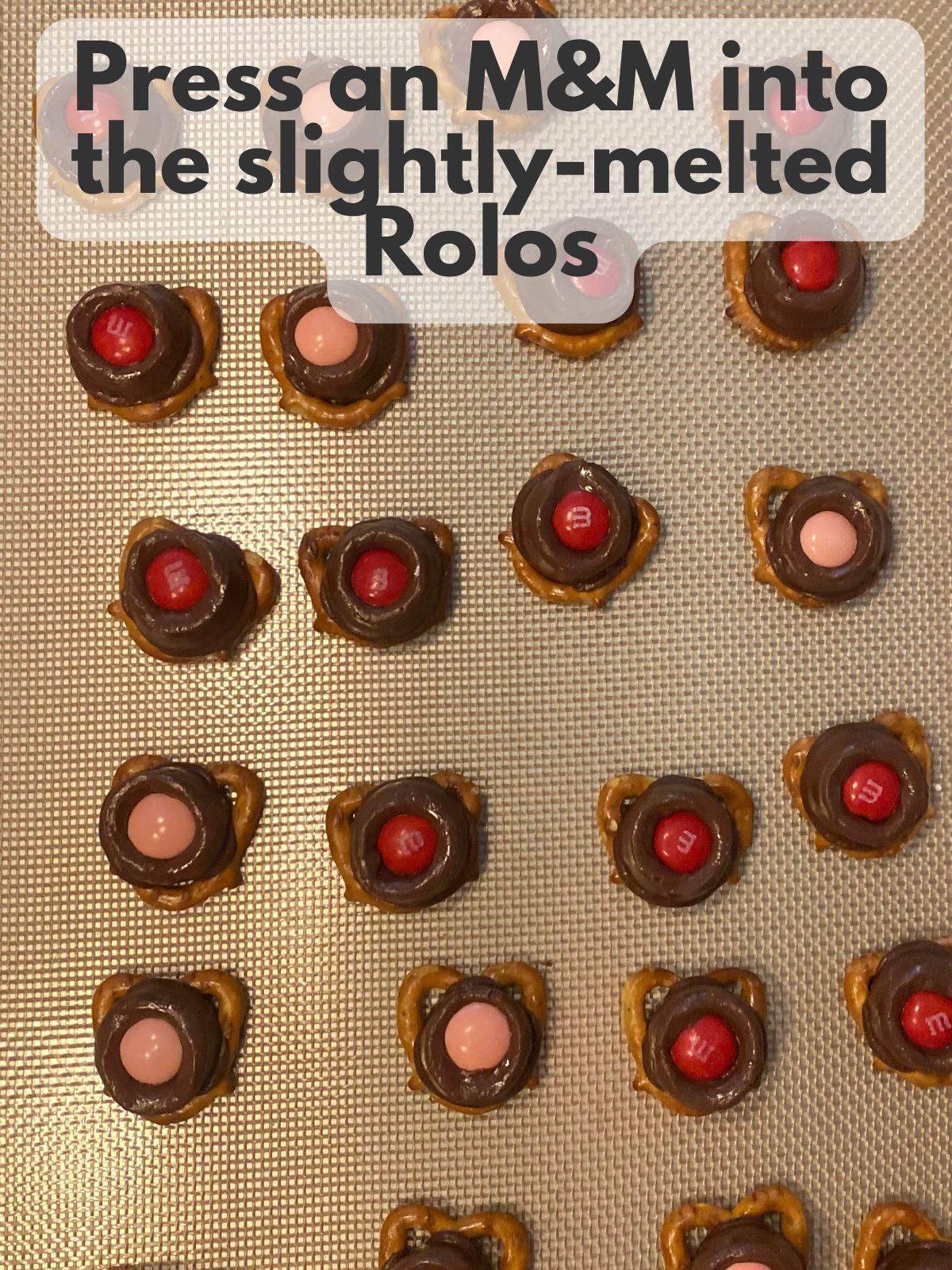 M&Ms pressed into melted Rolos on pretzels
