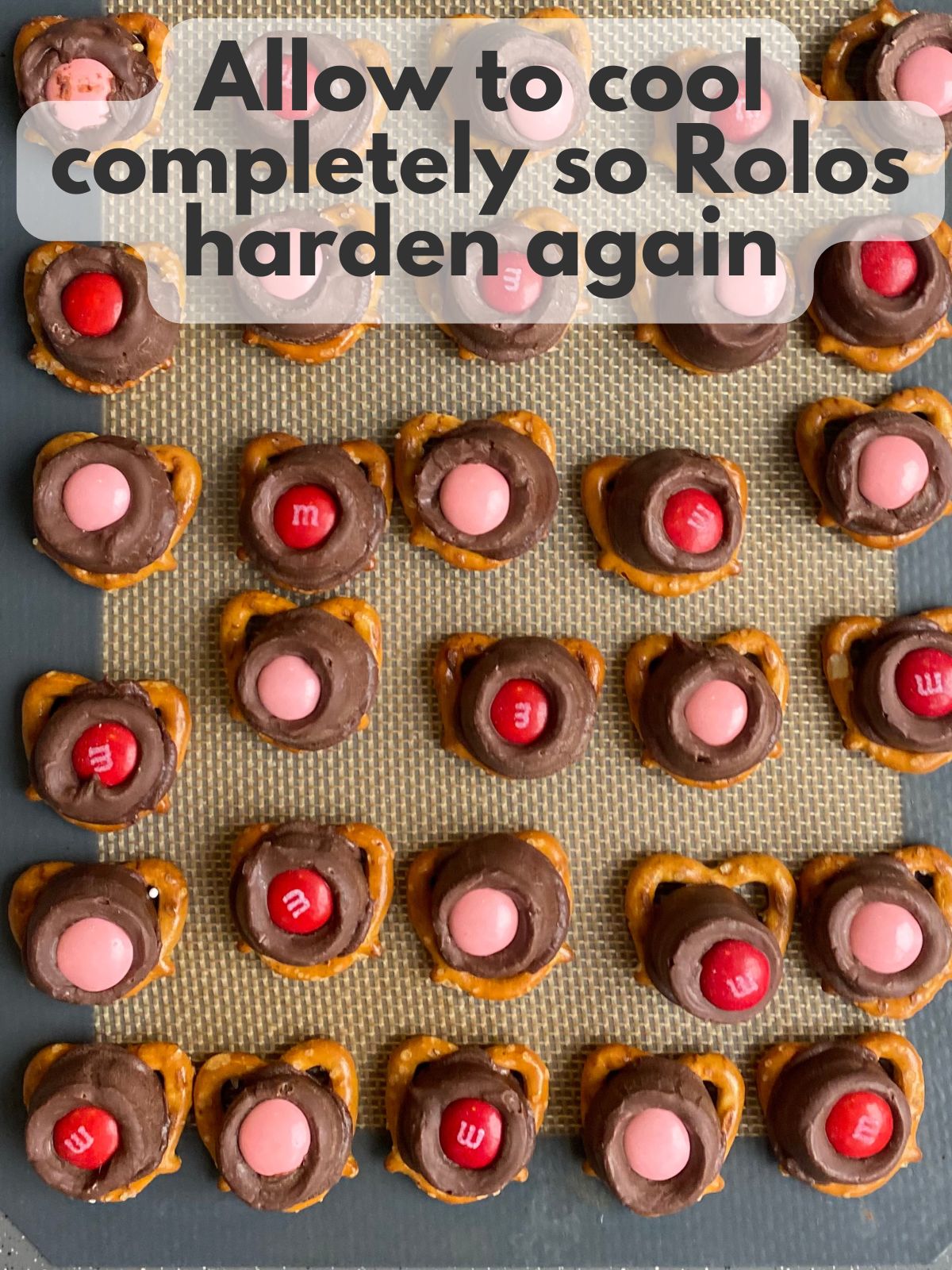 valentine's day rolo pretzels setting on a baking sheet