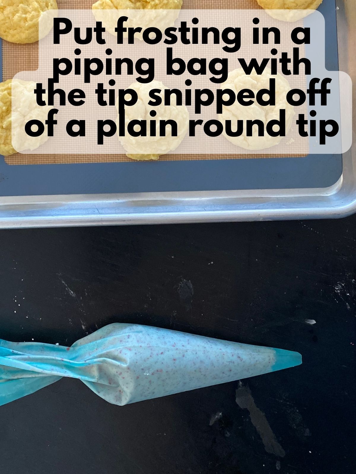 strawberry frosting in a piping bag next to a tray of lemon cake mix cookies