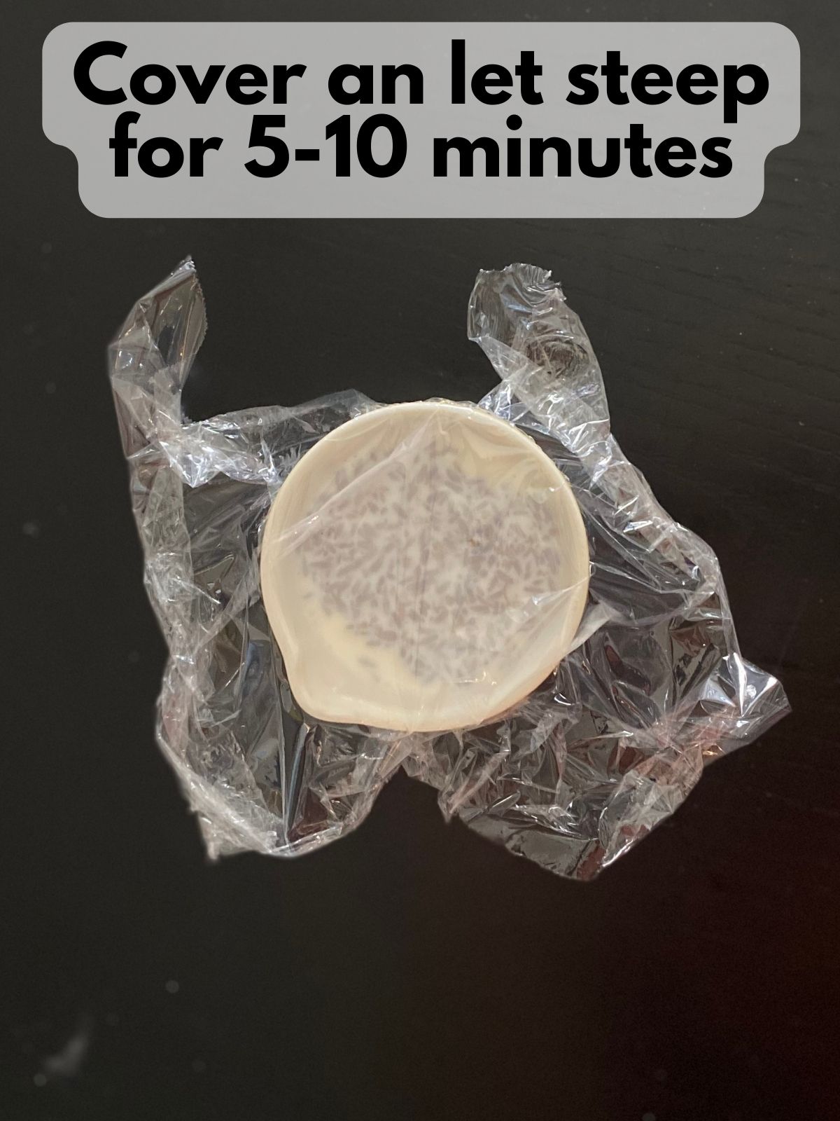 lavender steeping in hot cream covered in plastic wrap