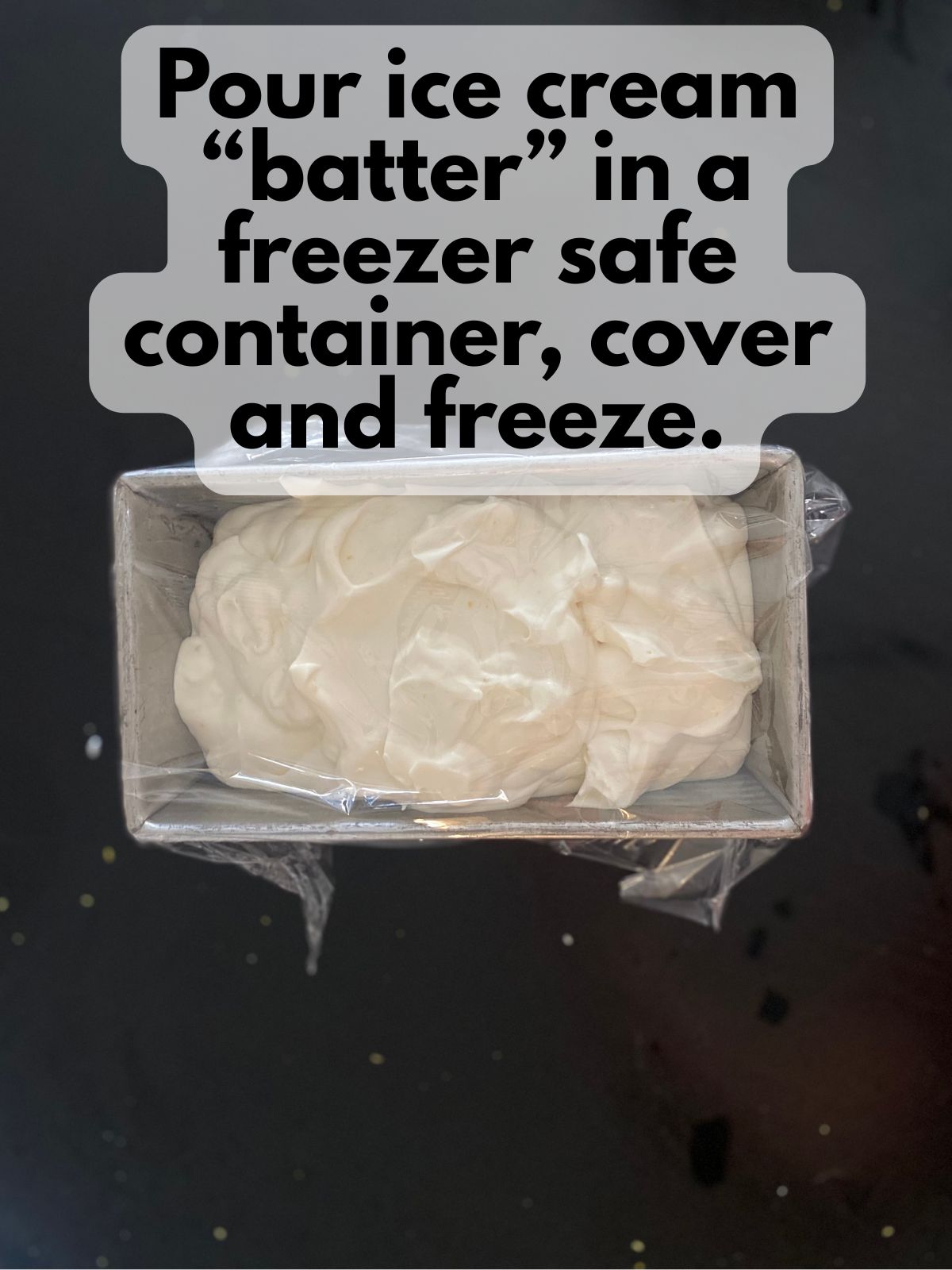 lemon lavender ice cream in a loaf pan covered with plastic wrap