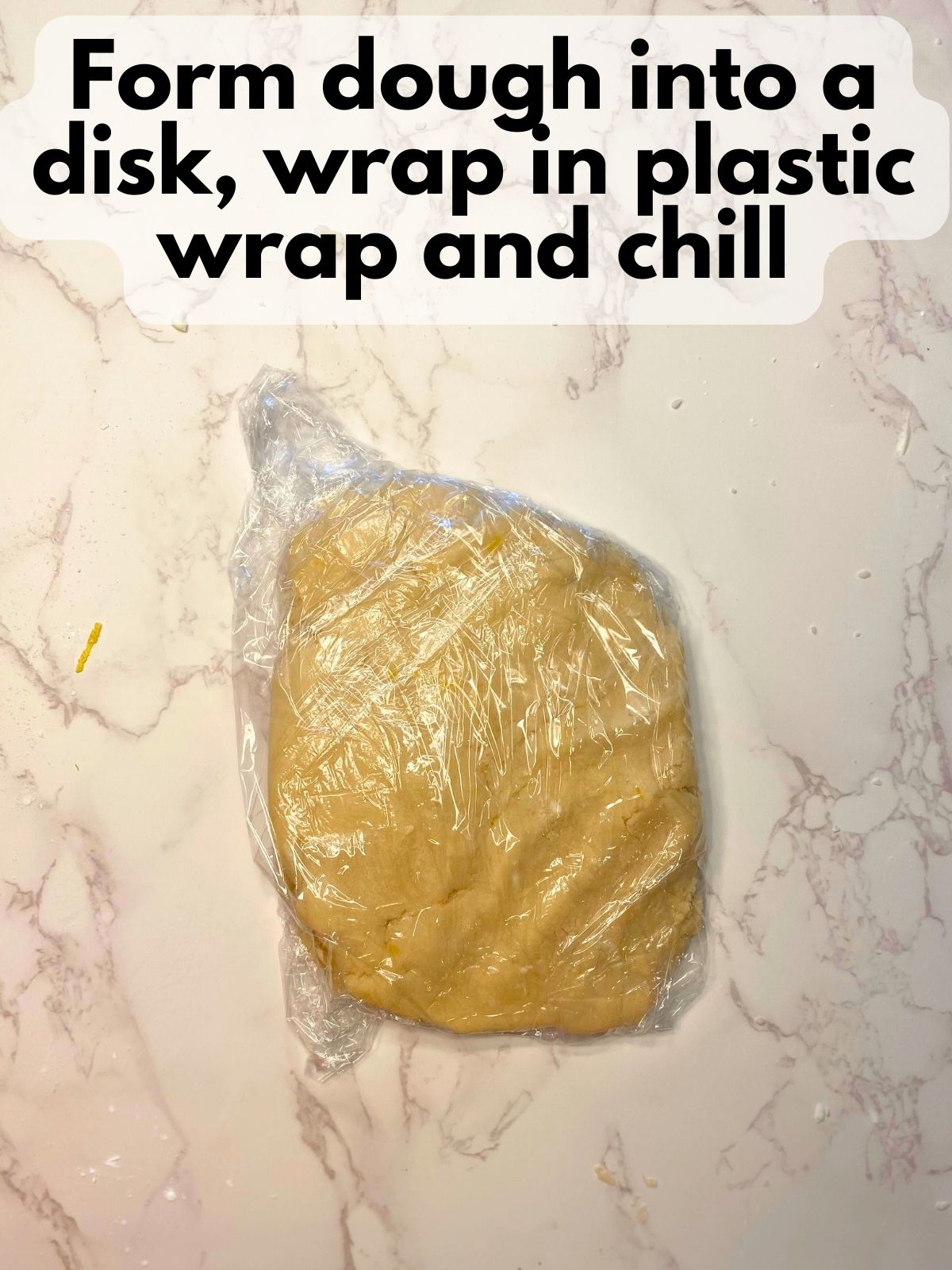 lemon shortbread dough wrapped in plastic wrap