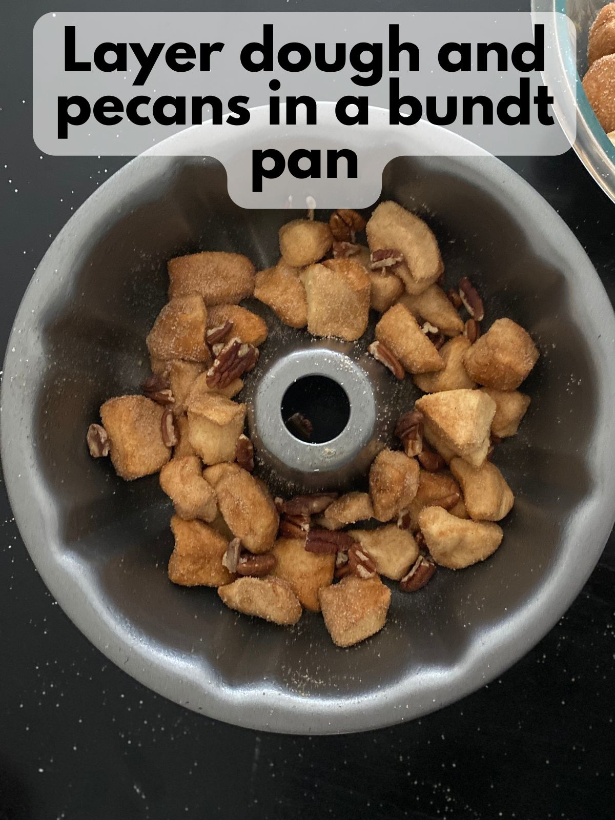 dough and pecans in a bundt pan