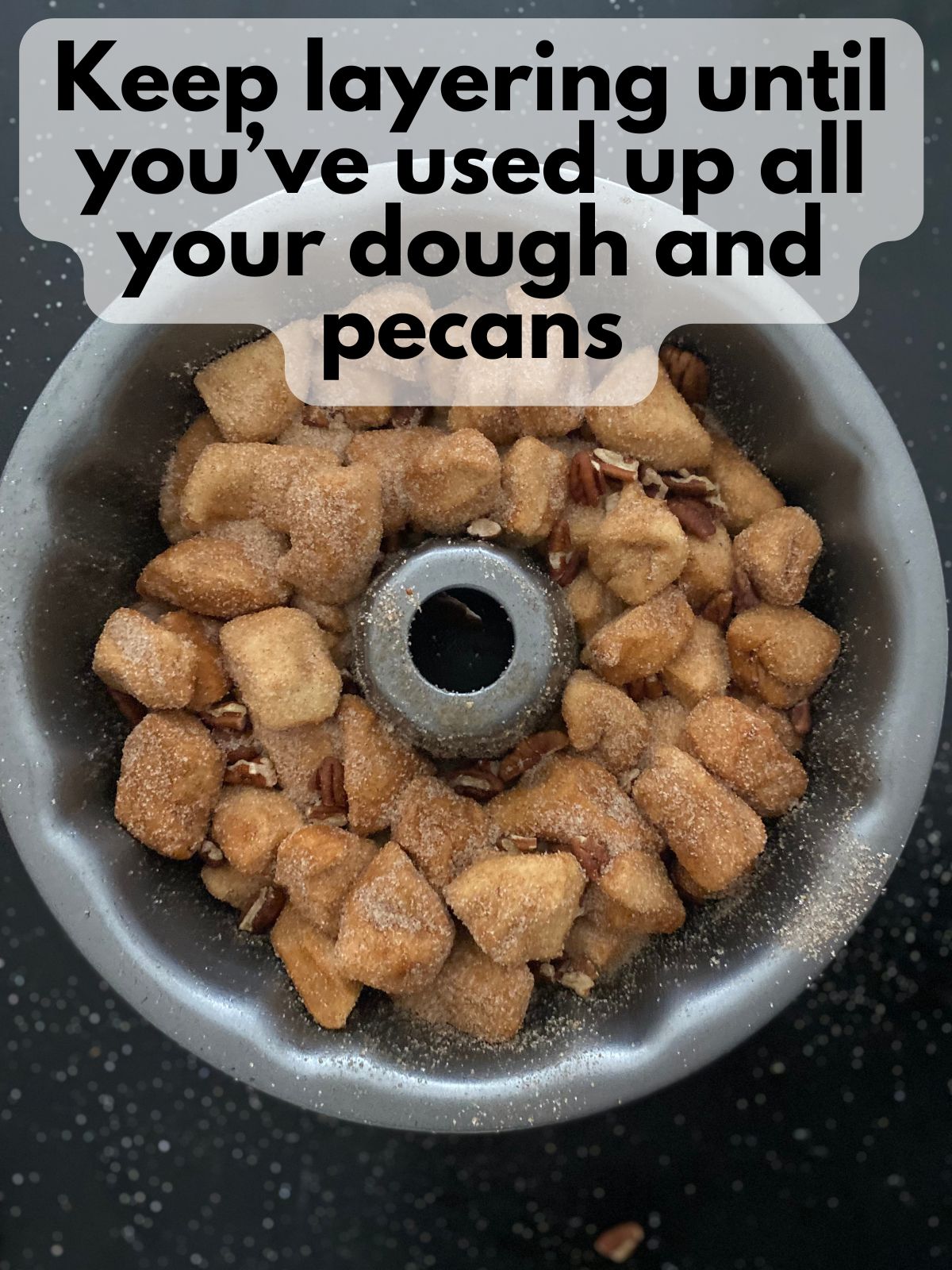 dough and pecans mixed in a bundt pan