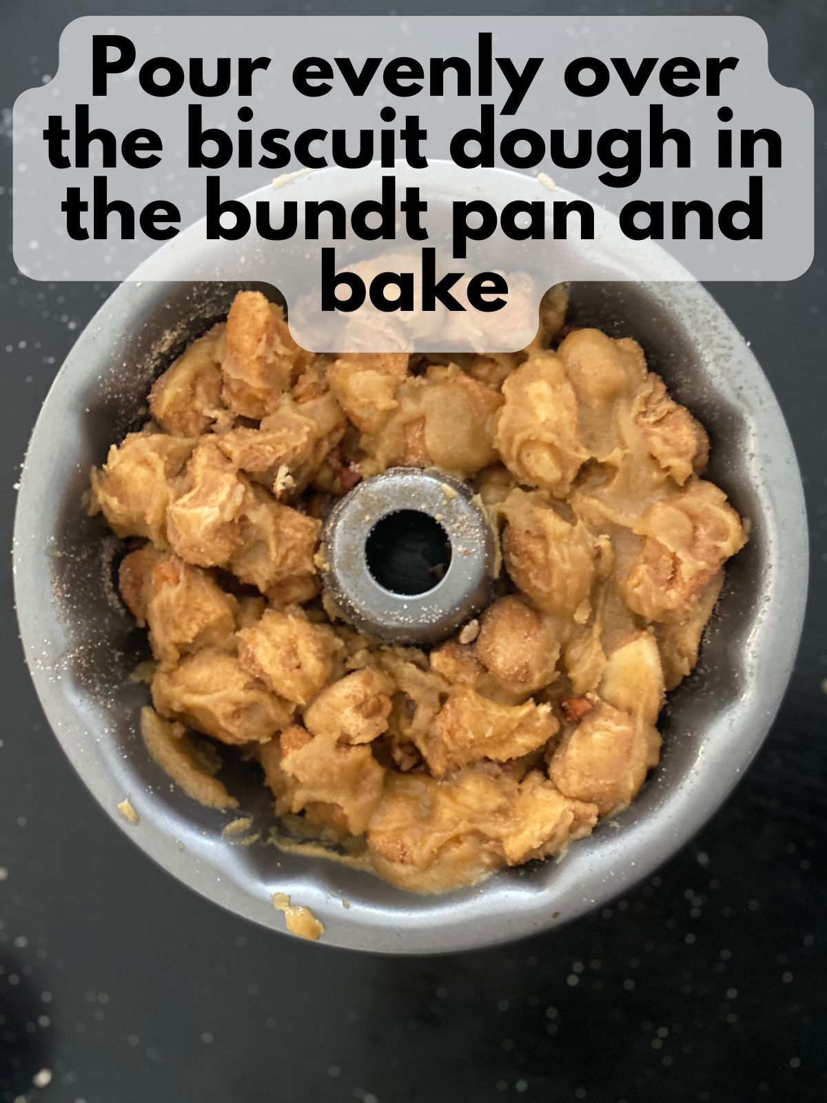 dough pieces coated in butter and brown sugar in a bundt pan