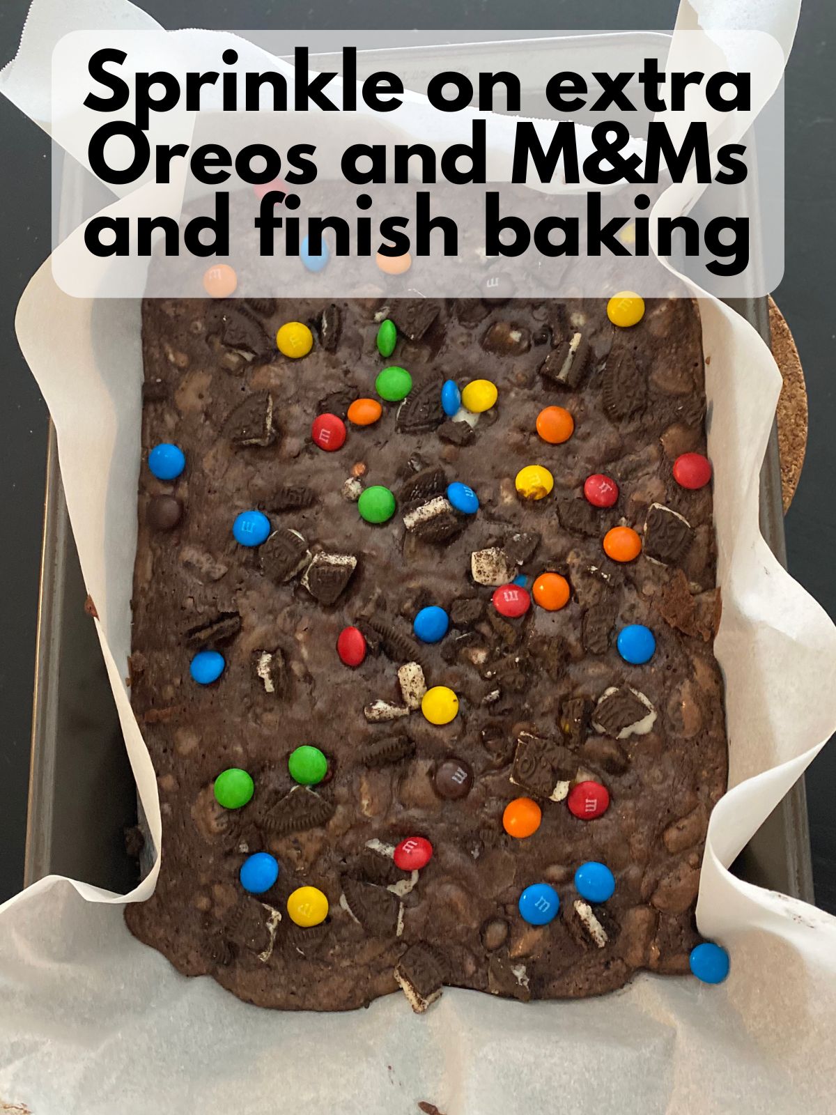 Par baked brownies with extra Oreos and M&Ms sprinkled on top