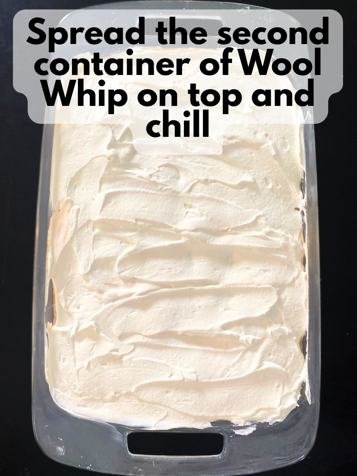 Cool whip spread on top of chocolate pudding layer