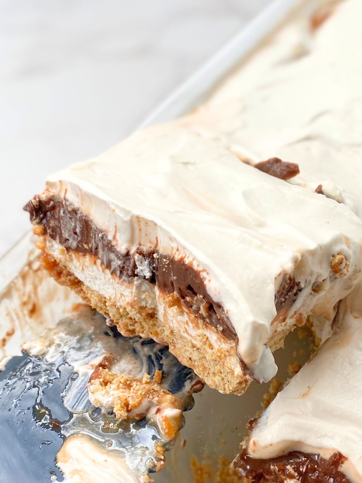 a slice of chocolate lasagna being lifted from the pan
