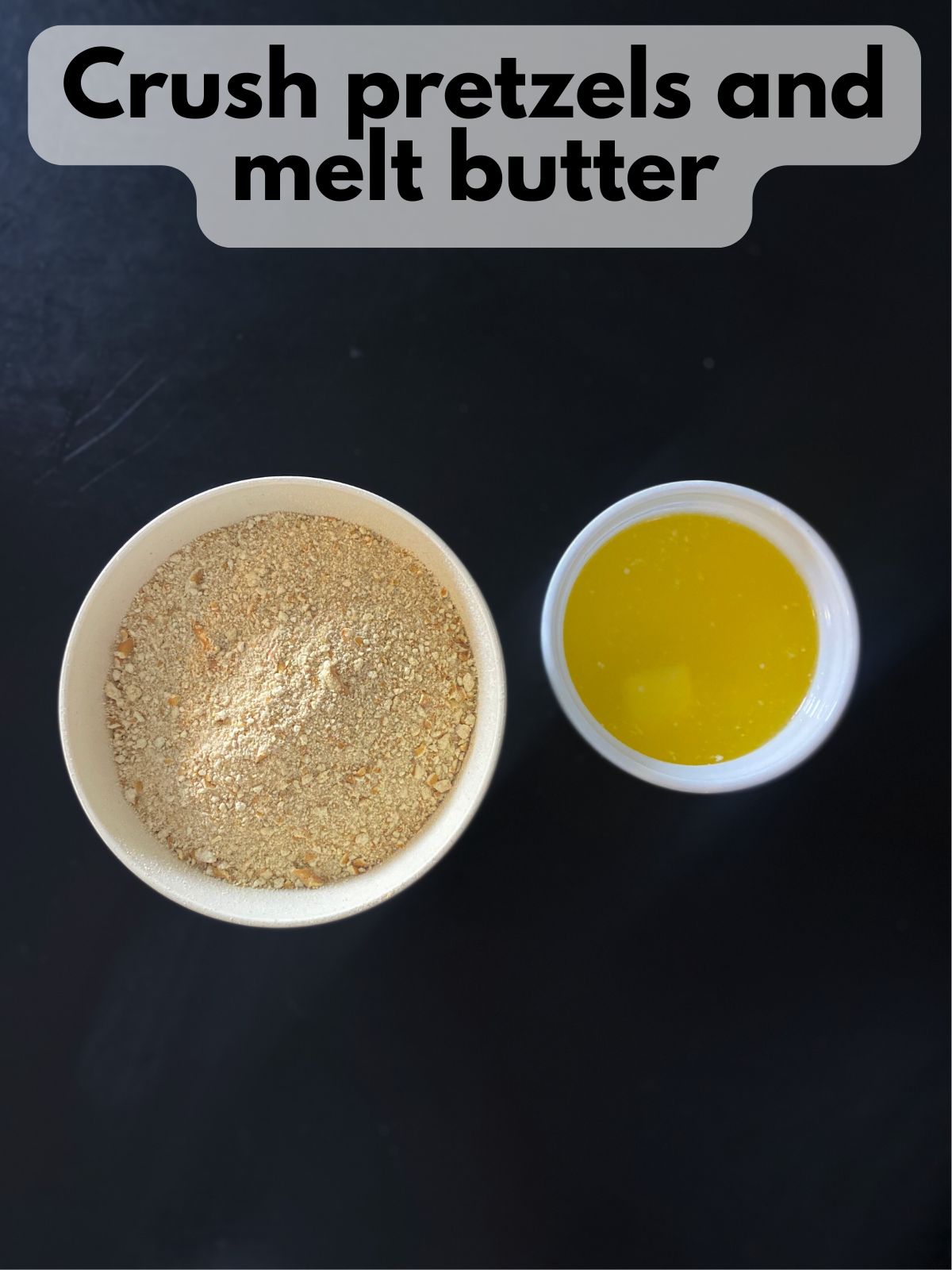 crushed pretzels in a bow next to a bowl of melted butter