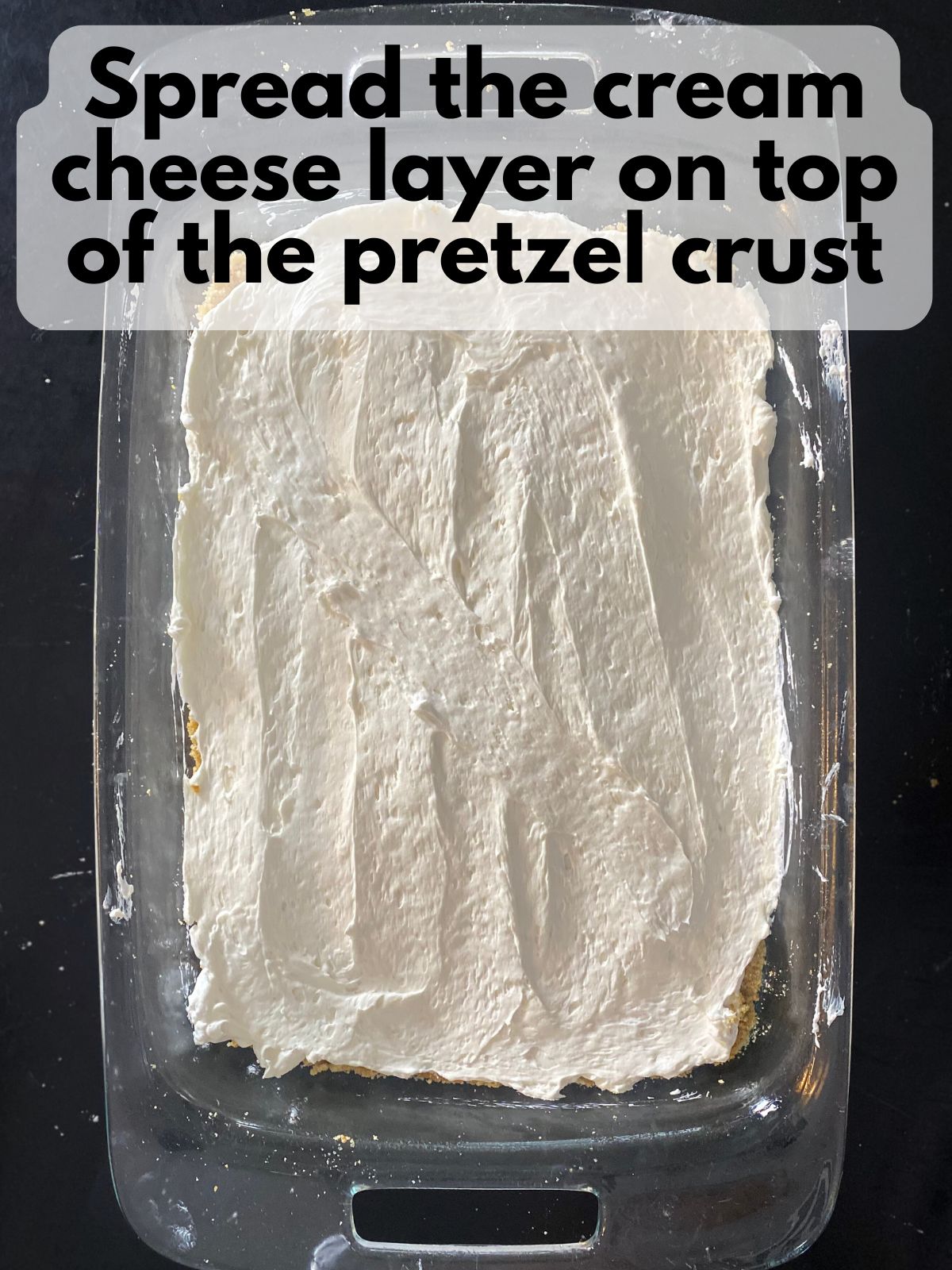 Cream cheese layer spread on top of pretzel crust