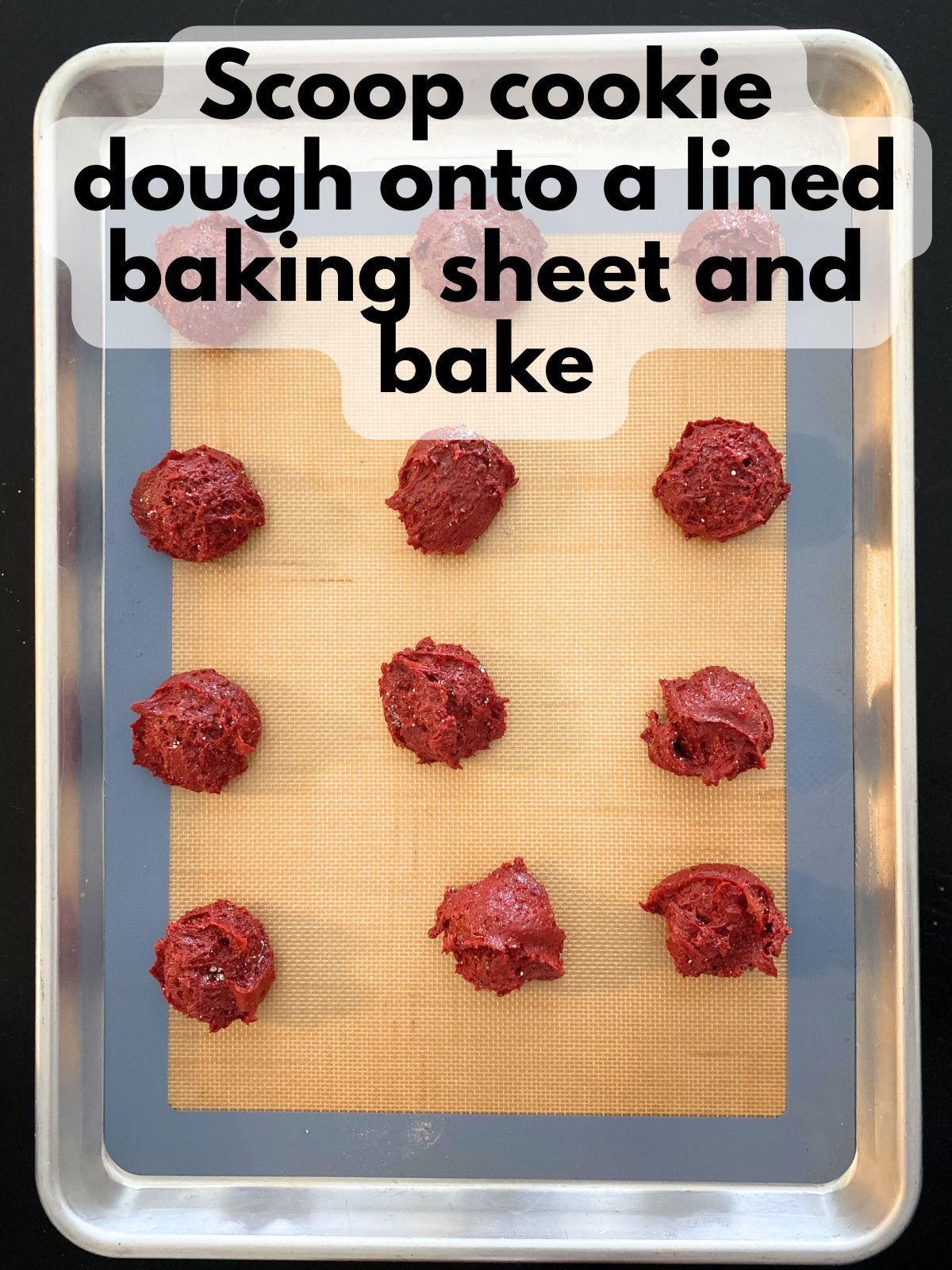 red velvet cookie dough scooped onto a baking sheet