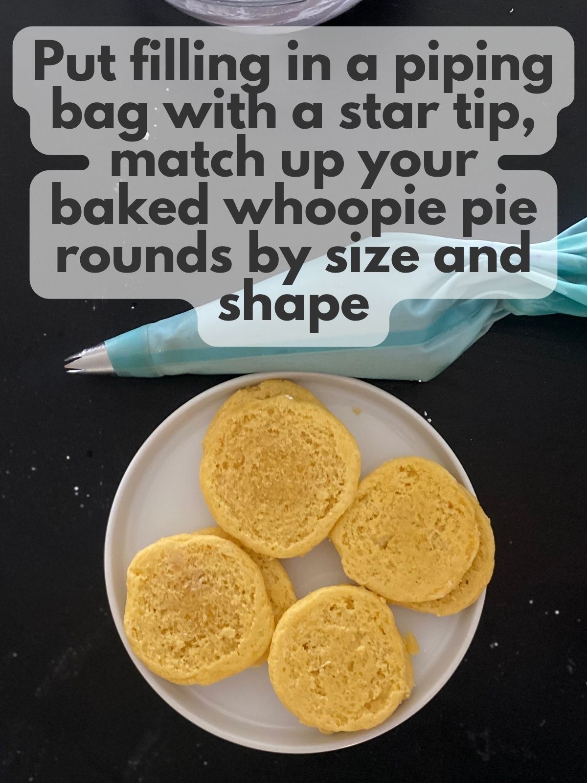 lemon whoopie pie rounds on a plate next to a piping bag with lavender buttercream