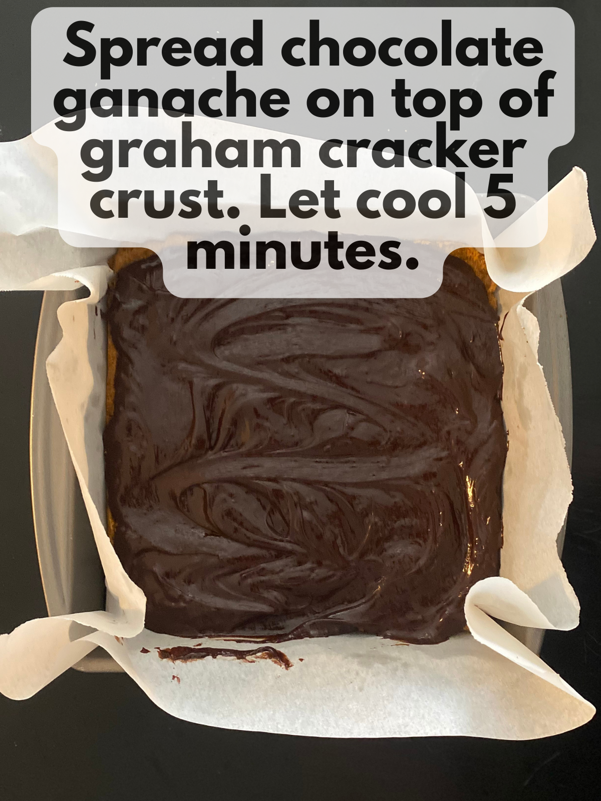 chocolate ganache spread on top of graham cracker crust