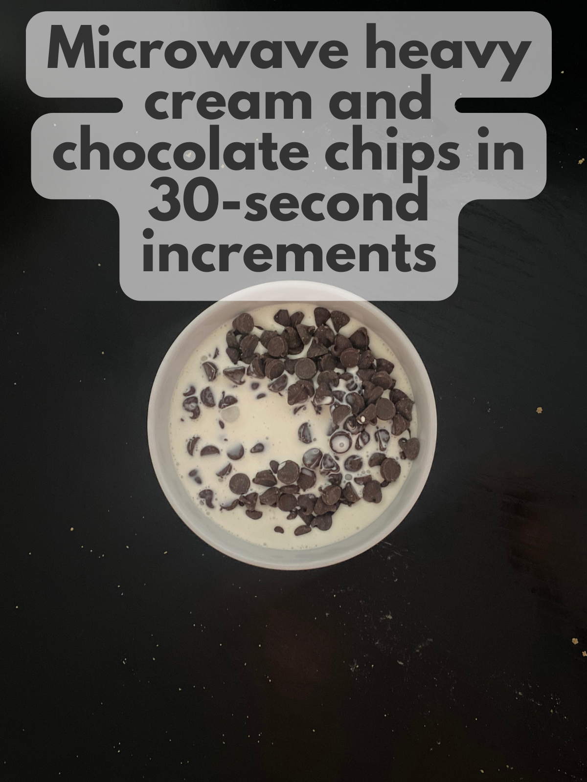 chocolate chips in heavy cream in a bowl