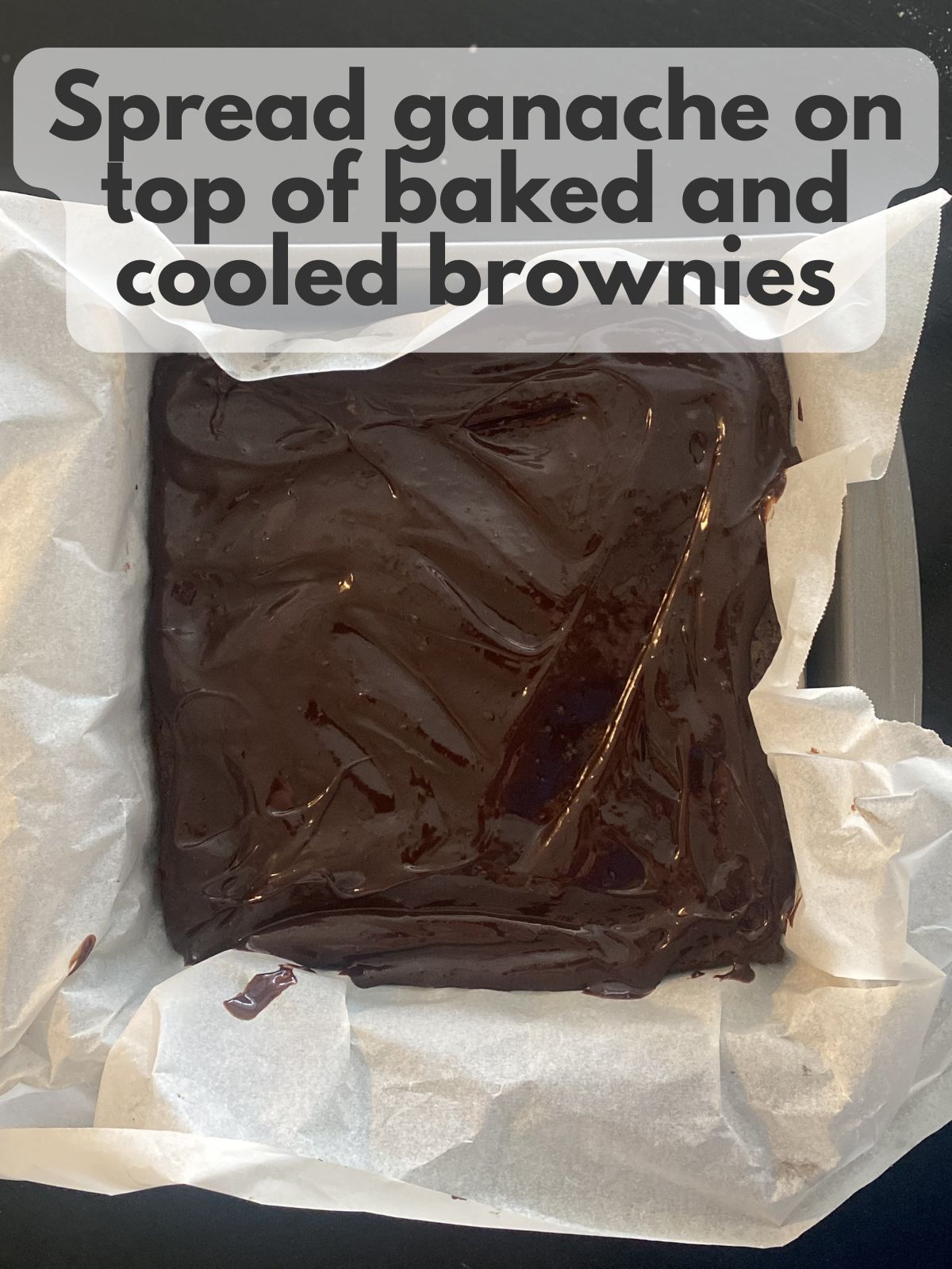 chocolate ganache spread on baked brownies