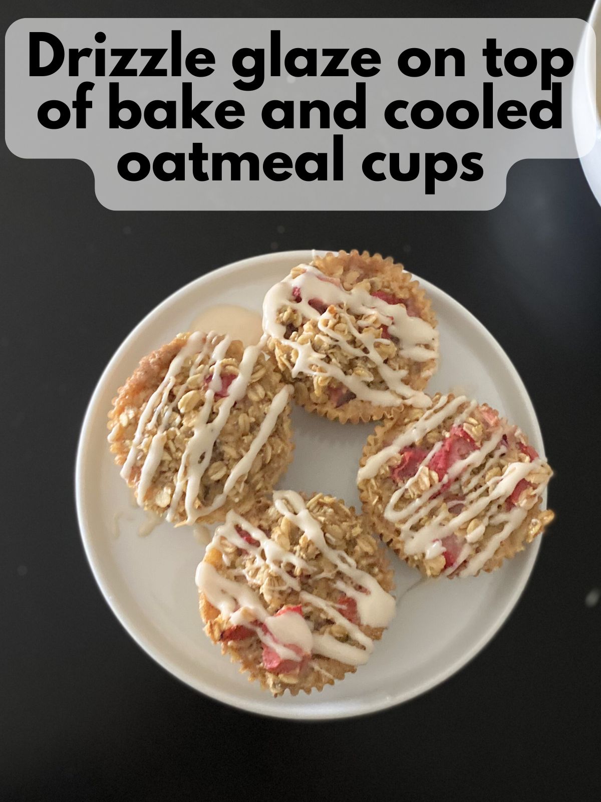 strawberry baked oatmeal cups with vanilla glaze drizzled on top