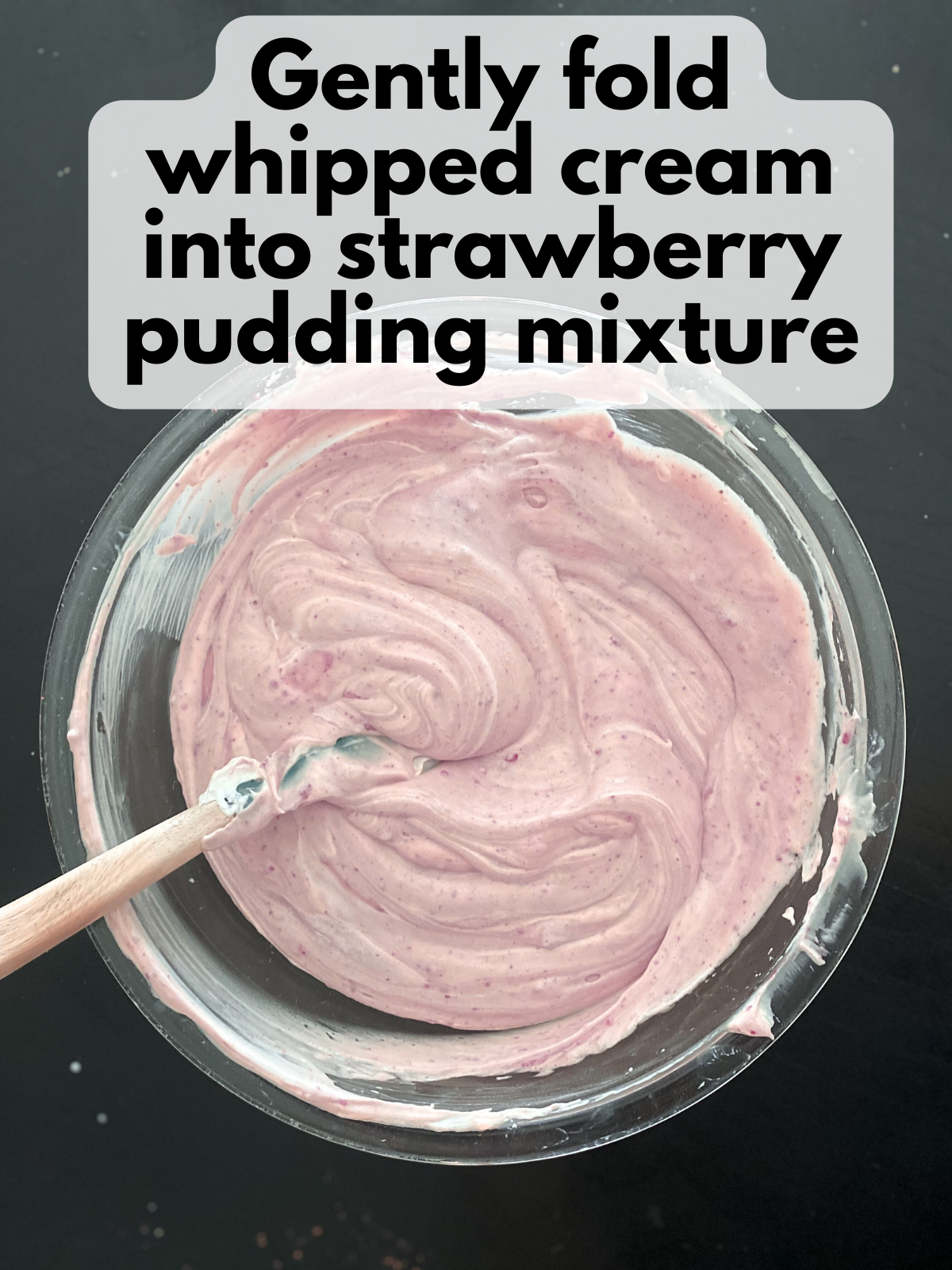 whipped cream folded into strawberry pudding mixture