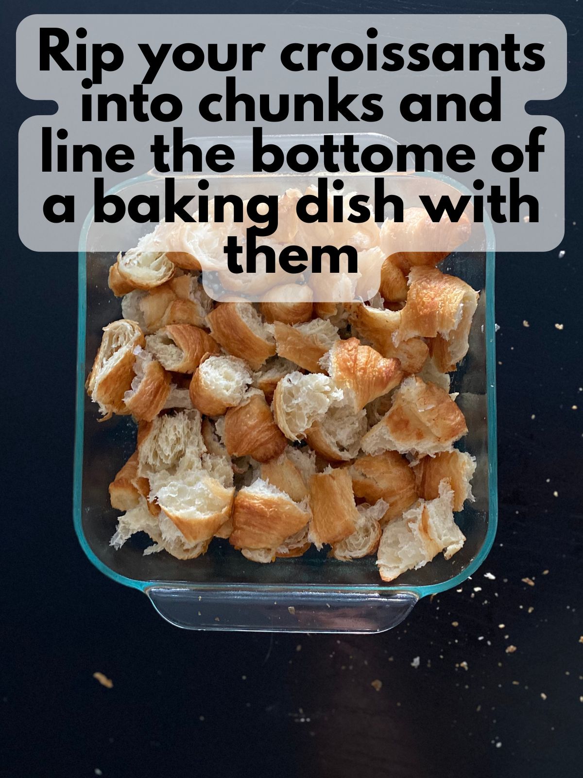 croissants broken up into chunks in a baking dish