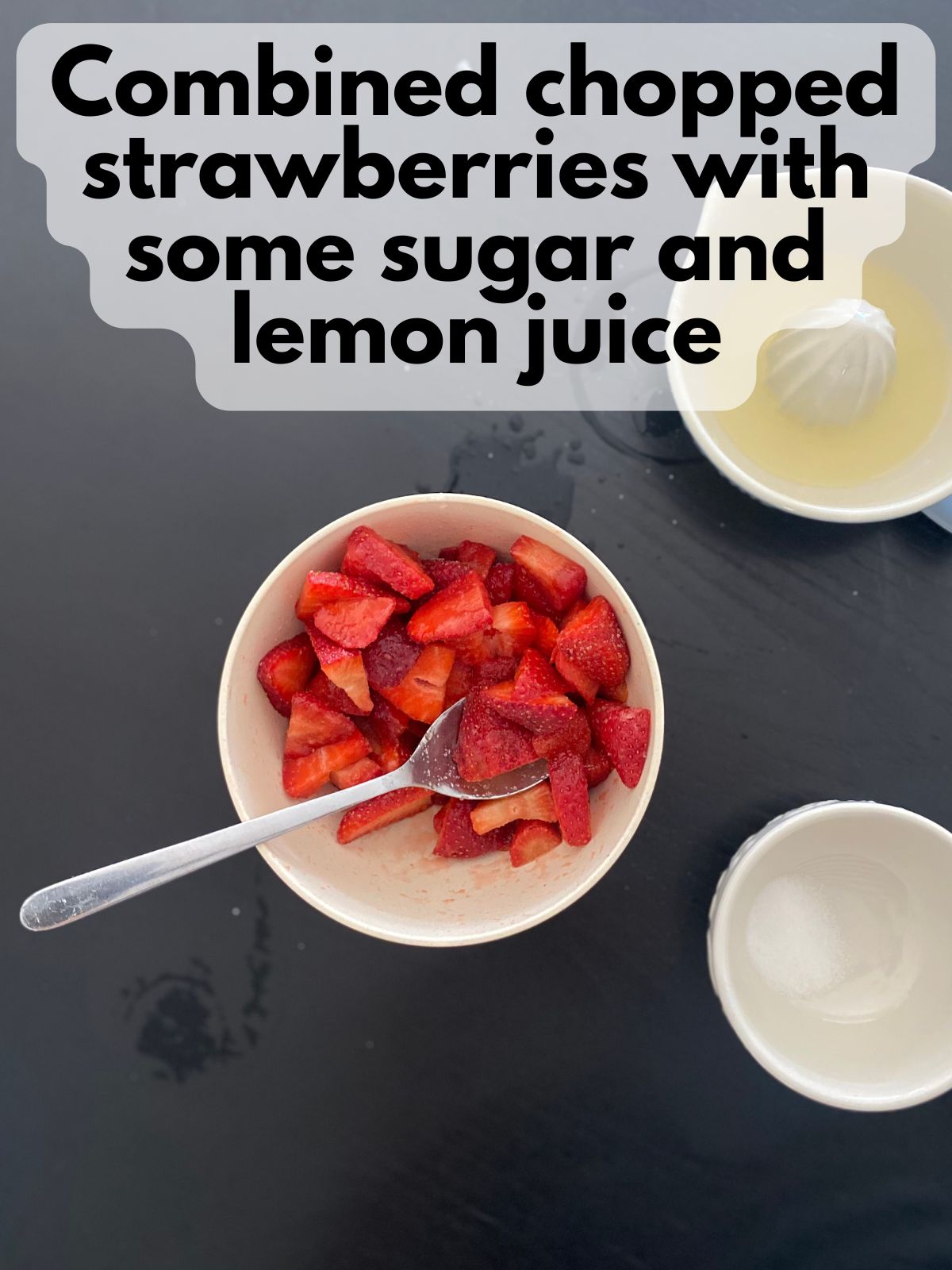 strawberries in a bowl with sugar and lemon juice